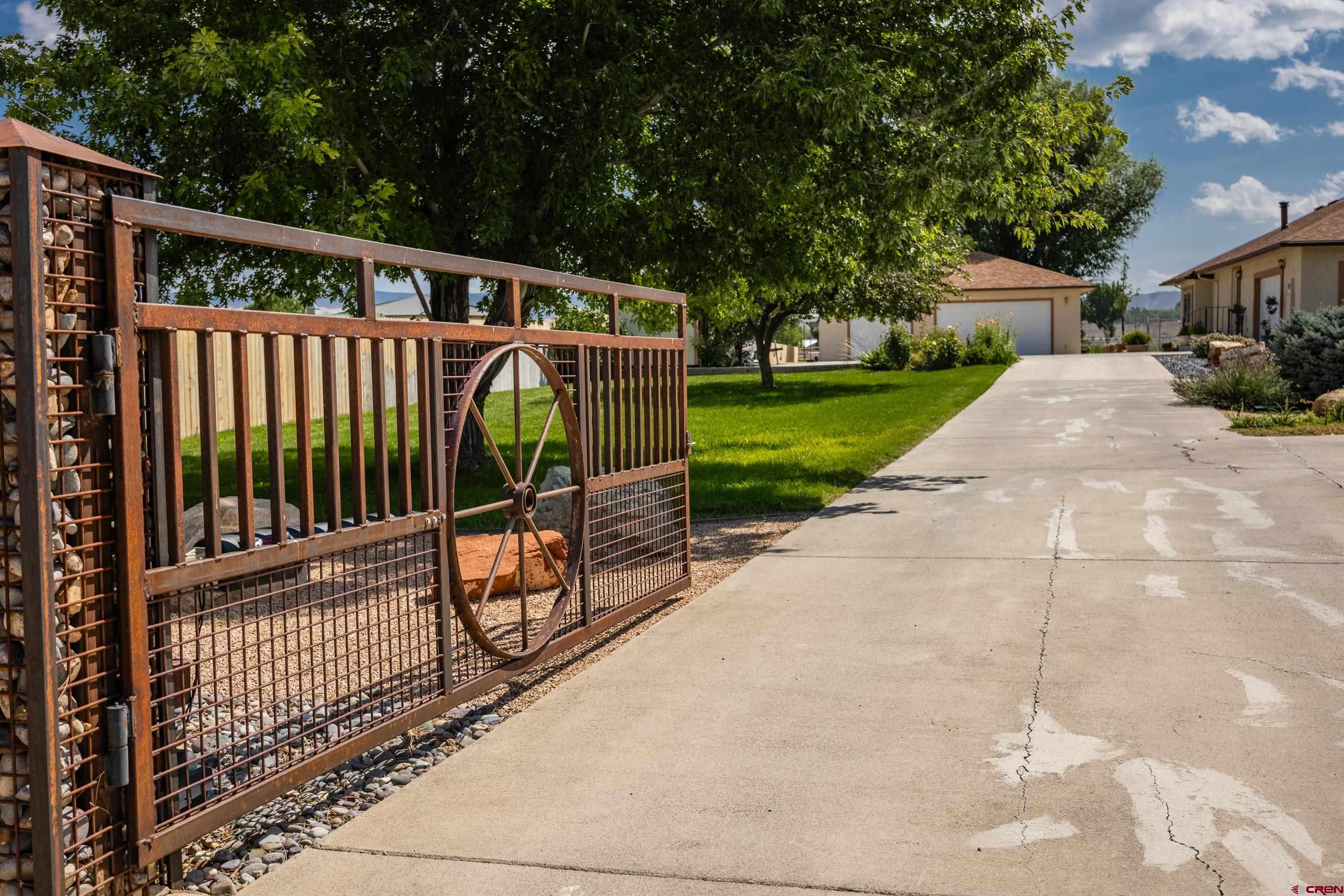 The electric privacy gate greets you to this 2.1 acre Mini Estate in Montrose Colorado.This property checks many of the boxes for todays buyers . Single attached garage and a 3 car heated detached garage/shop, RV setup with dump station and hook up, 2 acres with irrigation system for the park like landscaping around the home so that you can enjoy the great outdoors. Another acre with fruit trees, retention pond, Chicken coop / storage shed and room for critters.  The circular driveway gives company plenty of off street parking for get togethers. Then you enter the completely remodeled home with new oak hardwood floors, brand new dream kitchen that you have to see to believe. Much of the lighting is new.  Custom built-in cabinets , trim and interior paint leaves nothing for you to do but move in. No amount of words can describe all the details that have been done to this home. Great location only a few minutes to dining, golf, and shopping . Seeing is believing .