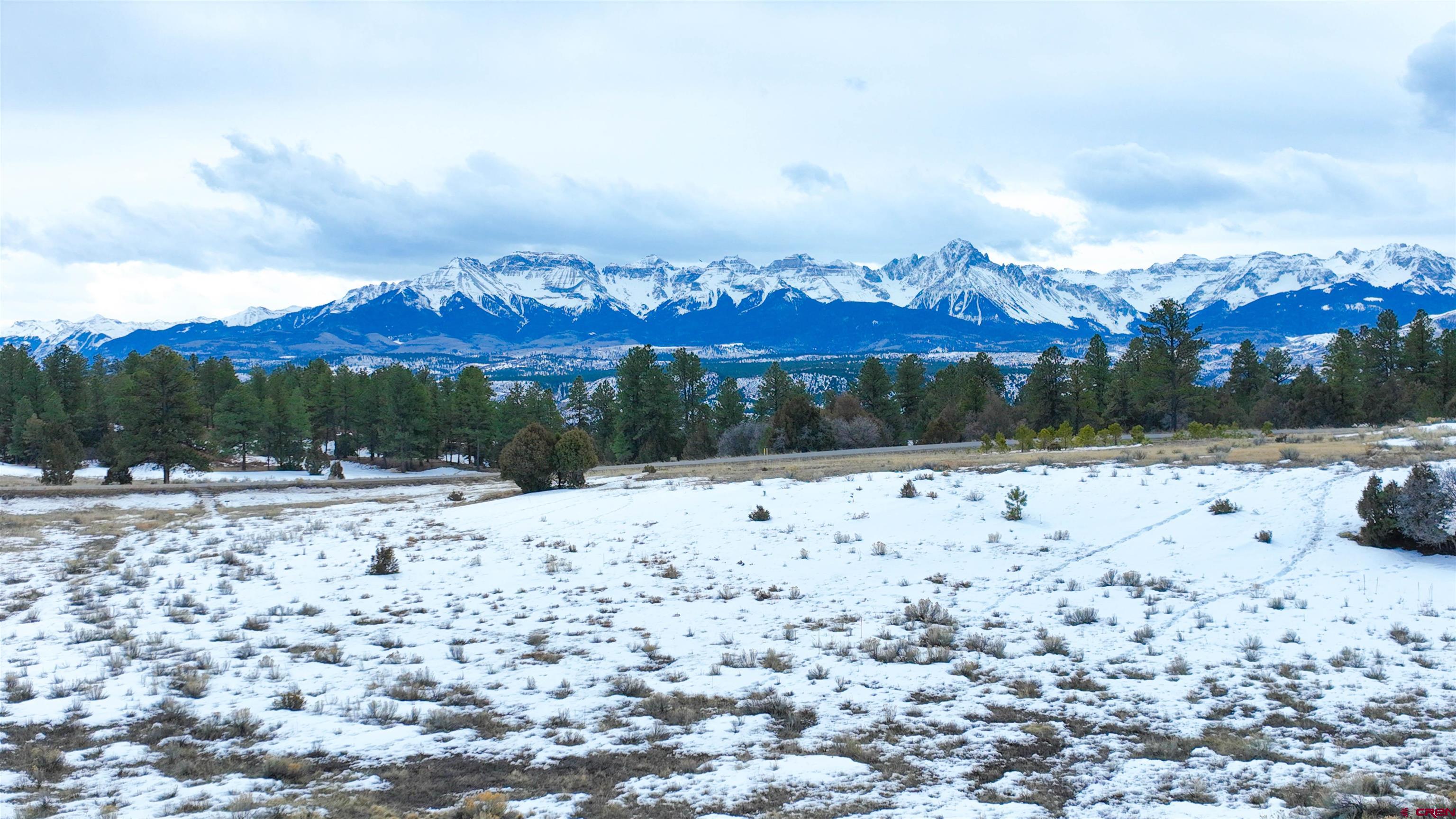 This 3+ acre parcel of land offers a unique opportunity to build a stunning home, nestled in the heart of Colorado's recreation-rich San Juan Range. The direct views of the San Juan and Cimarron Mountain Ranges, including a clear view of Mt. Sneffels, make this property a rare find. Additionally, its location adjacent to a vast open space and overlooking the #3 Fairway and green of Divide Ranch and Club. The property's elevated location also provides a high-mesa forest of pinon, juniper, and ponderosa pine, and breathtaking views of four Rocky Mountain peaks in Southern Colorado near Telluride. Its location is conveniently situated, just four miles from Ridgway, less than 30 miles from Montrose and its regional airport, and a short drive from Telluride, Ouray, and Black Canyon National Park.  This parcel of land offers a rare opportunity to create a homesite in an area surrounded by natural beauty and recreational opportunities. Its location and features make it a highly desirable option for those looking to build a dream home in a picturesque and accessible location. We encourage you to seize this opportunity and schedule a viewing of this exceptional property today.