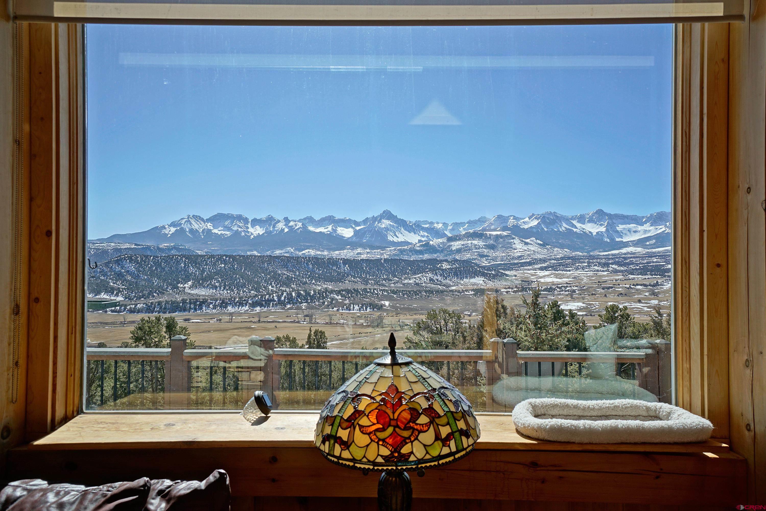 When you think of the Colorado and your dream home, it is about the mountain views.   You want a home with the BIG mountain views.   What does that mean?  You want to see Mt Sneffels framed by your living room windows.  You want to see all of the San Juans and all of the Cimarron Mountains.   You want to see Chimney Peak and the Courthouse turn yellow, orange, pink, lavender with the evening Alpenglow.   This Pleasant Valley 4 bedroom, 3 bath home situated on 3.14 acres checks all of the boxes.   Come in the front door and immediately you are surrounded by the cozy warmth of post and beam construction.  The open floor plan flows from living room, kitchen and  to dining room.  2 Sided Fireplace warms living room and kitchen open space.  There are 2 master suites, one on the main level and one on the upper level.  The lower level features 2 bedrooms, one full bath, living room, sun room and walk out to the garden.  It is a home which invites the outside inside with decks bounding the dining room and living room.  Need space for vehicles and toys?  Got it with an oversized 2 car detached garage with studio space above.  Well established yard and garden with drip system is fenced for you and your pets enjoyment.  Pleasant Valley is known for its magnificent mountain and valley views.  It is a location close to where you want to go.  15 mins to the Town of Ridgway, 40 minutes to Telluride, less than an hour to the Montrose Airport.    Hike, bike, walk, run right from your front door.
