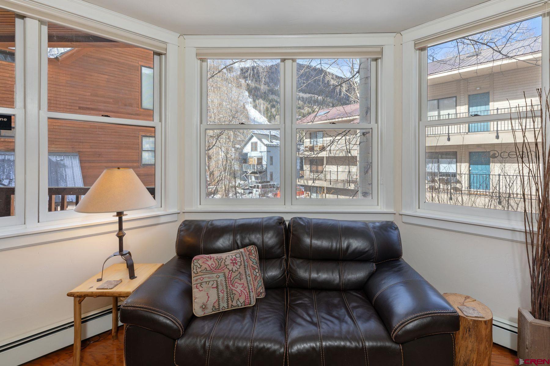 South Cornet Creek #403 is unique among its one-bedroom peers, with a sun-filled open floor plan and a one-car garage. Enjoy everything Historic Telluride has to offer - from world-class skiing to top-flight festivals - with this super clean gem that lives like a home. The bedroom and the full bath are spacious, and you can relax to the soothing sounds of Cornet Creek on the south-facing deck. The kitchen is finely appointed and the living spaces enjoy ample room for entertaining. Boasting views of Ajax Peak, Ingram Falls, and the ski trails descending to the valley floor. The unit has a washer/dryer, a generous owner closet, a ski locker, and a STR license. The comfortable spaces, the garage parking, and the easy access to all things Telluride have generated solid rental revenues.