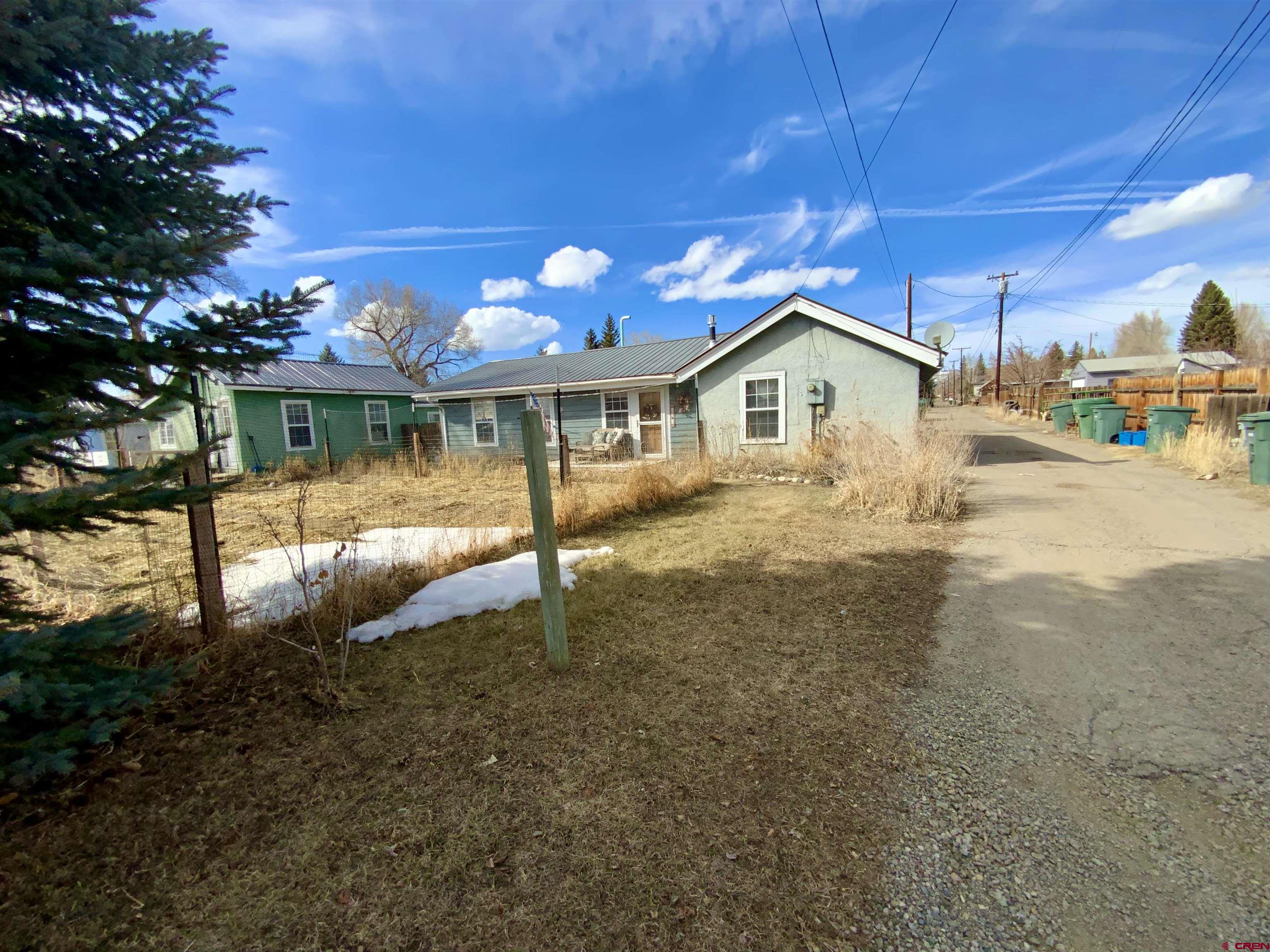 This is a great opportunity to own 4 rentals in the town of Gunnison!  The property has 2 studios, a 1 bedroom/1 bath house and a 2 bedroom/2 bath house. The 2 bedroom house has a detached garage with workshop space. Property features a community garden for all the units.  Location is close to the High school and Elementary schools and RTA bus stop. Property is partially fenced for pets. Tenants are paying all utilities.