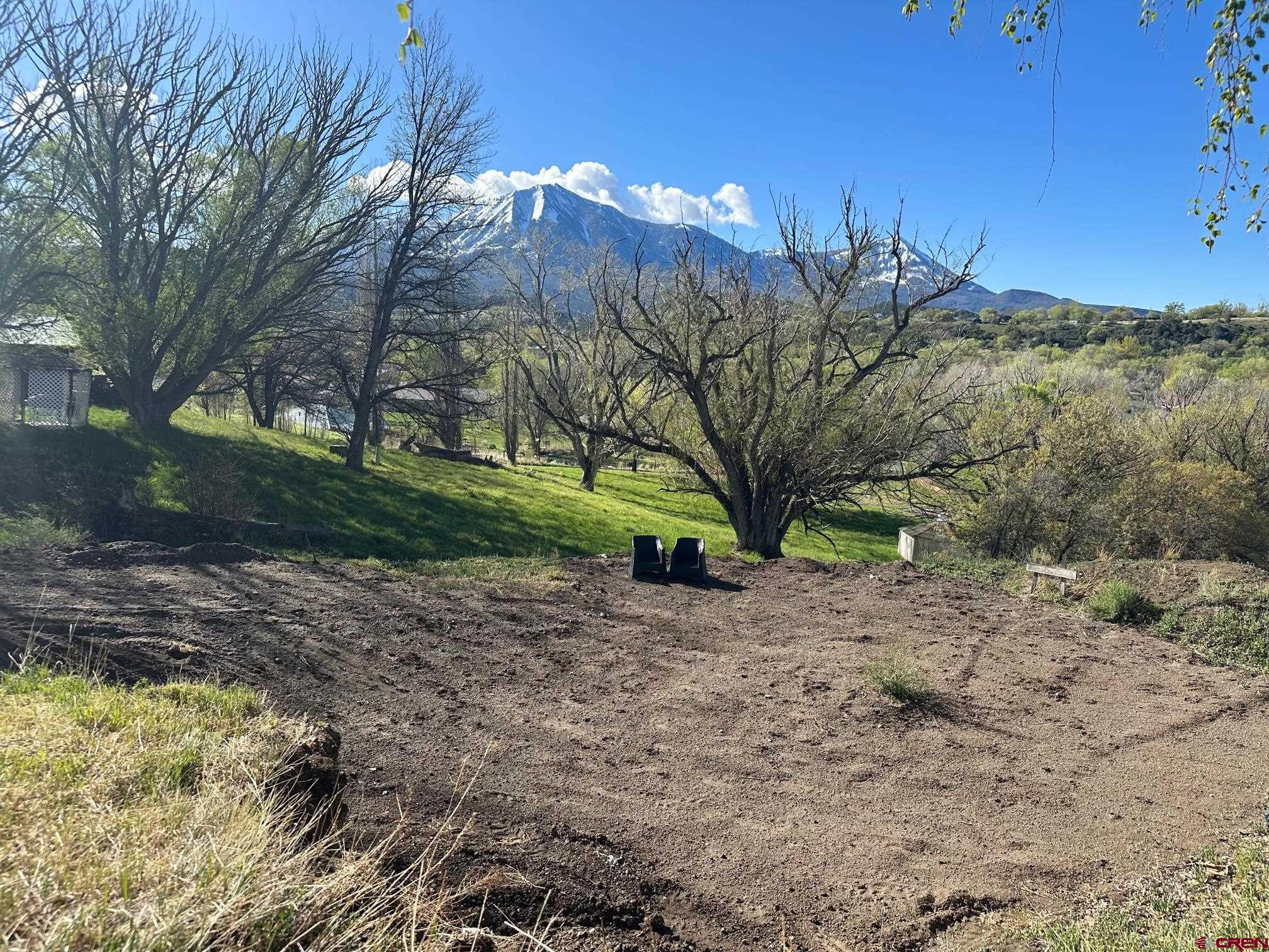 Paonia Town Lot with Mountain Views! Don't miss this opportunity to create your dream home in a picturesque setting with convenient access to amenities and breathtaking views. This lot comes with a Town of Paonia Water Tap, Sewer Tap, Irrigation Water, and Electric. It is located in walking distance to downtown Paonia and Jumbo Trail System.  The path in front of the  property takes you to Apple Valley Park which features tennis courts, pickle ball, playground, creek, and a workout area. Build your dream home today in Paonia!