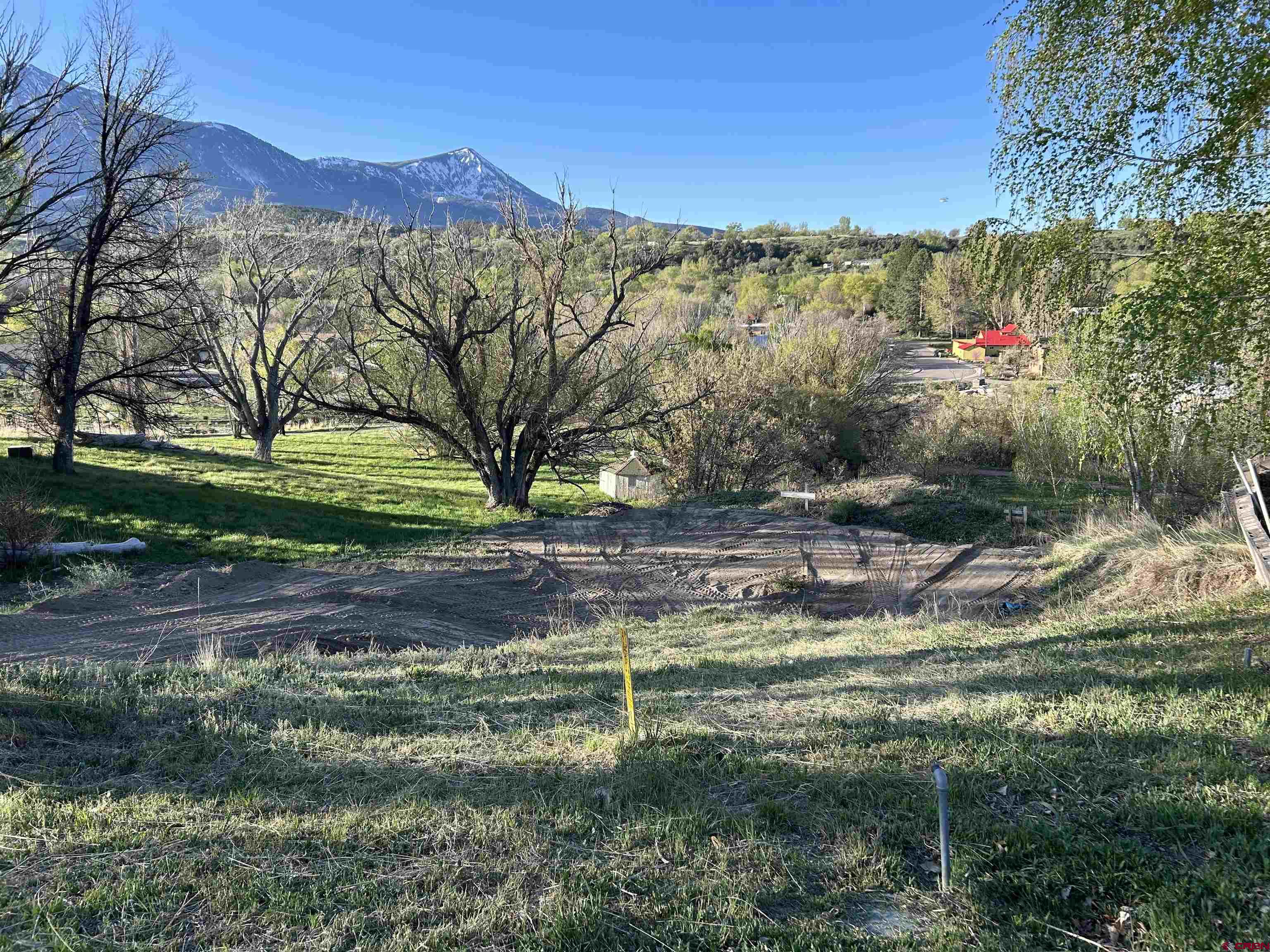 Paonia Town Lot with Mountain Views! Don't miss this opportunity to create your dream home in a picturesque setting with convenient access to amenities and breathtaking views. This lot comes with a Town of Paonia Water Tap, Sewer Tap, and Electric. It is located in walking distance to downtown Paonia, Jumbo trail system and Apple Valley Park. The path in front of property takes you to Apple Valley Park which features tennis courts, playground, creek, and a workout area.  Build your dream home today in Paonia!