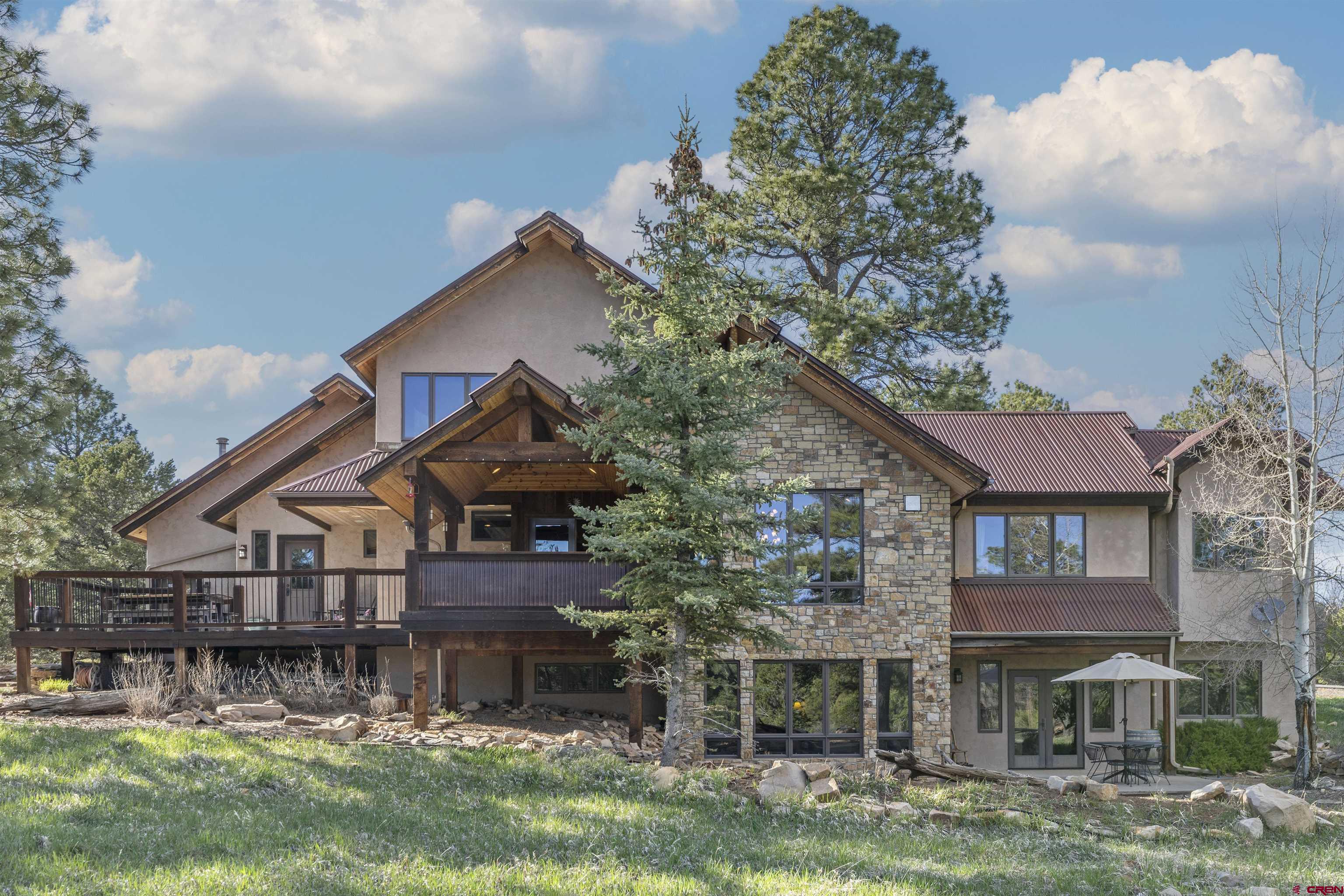 This Divide Ranch and Club home is located on the 11th tee box. This home is ready for someone looking for that perfect mountain retreat. The trees are aspen and ponderosa pine, allowing for incredible privacy. The views are of the golf course and the mountain peaks of the Cimarron, San Juan and Sneffels Ranges. There is forested open space in the back yard that includes an extensive patio, a fire pit and a very comfortable covered deck. Travertine tile flooring on both levels with new oak flooring as well in the lower level. The upstairs has a great room with a large open kitchen, which flows into the living room. The covered deck is situated right outside the dining area and creates a comfortable outdoor living area. The primary bedroom on the main level has a large walk in closet with a great master bath. Two bedrooms and a flex room are located on the lower level along with a large family room and a full sized bath. The exterior is stucco and stone. The interior has been professionally painted in 2022.