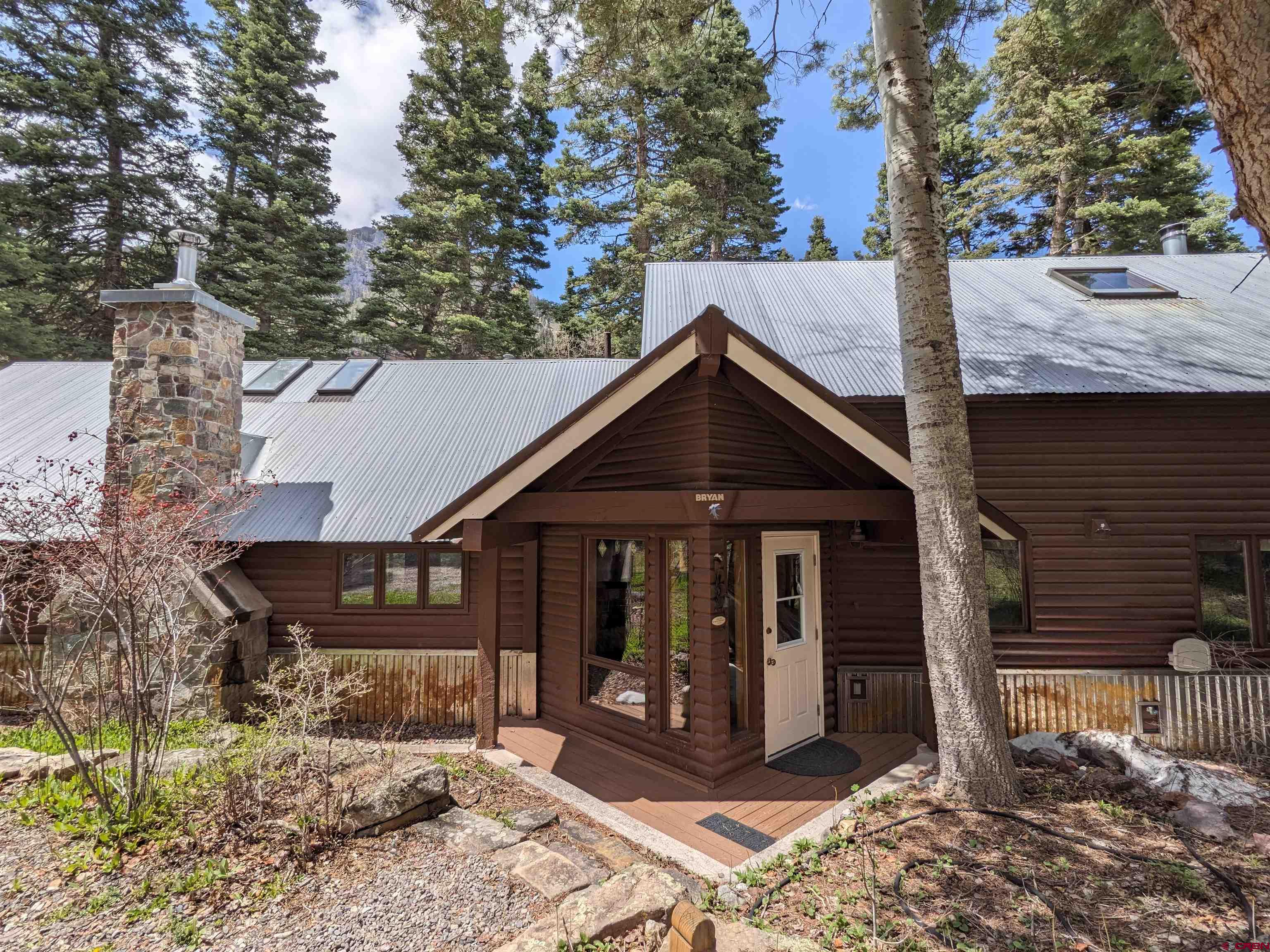 This cozy cabin is locating in the popular Mineral Farms neighborhood south of Ouray, Colorado. The original cabin was built in 1959 and then there was an addition added in 1989. As you enter the house you are greeted by a nice light and bright entryway leading to the kitchen. The kitchen has all new appliances and a cellar accessible via a trap door in the kitchen floor. The dining room and living room are apart of the original cabin. There is a stacked stone wood burning fireplace (replaced in 2022), screened in covered back porch, a guest bathroom and two guest bedrooms off the living area. The laundry is located off the hallway leading to the primary suite. The primary bathroom has a bathtub, shower, two vanities and a separate toilet area. The suite is very spacious with a seating area, walk in closet, wood burning fireplace, windows and private screened in covered porch. Above the master is an amazing studio loft with beautiful beams, lots of windows, skylights, a half bathroom and a lot of storage room. The two car heated garage was built in 1997. It's oversized and has room for their current woodworking area in the back as well as a utility sink. Above the garage is an ADU with a kitchen bar area, bathroom with a shower and storage room. The house sits on one acre with big mature Aspen and Pine trees. Lots of different wildlife visit this property including, deer, fox, bobcats, turkeys and lots of other birds. The property owners have access to the Mineral Farms ponds for fishing and relaxing. Guests are welcome too but must be accompanied by the property owner. Short term rentals are allowed on this property but are subject to the counties rules and restrictions. Come see what this peaceful property has to offer you!