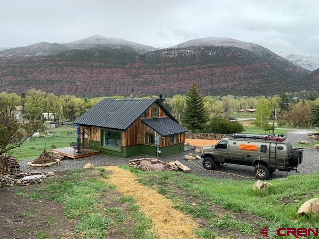 Welcome to your dream cottage in the Idlewild Estates at the entry of the Ouray Valley into the breathtaking San Juan mountain region 7500 feet altitude, large Ponderosa Pines aspens oak trees, running water with water rights. Charming new construction fully restored hand, brushed Barn-wood lodge, exterior with meticulously groomed, landscaping with beautiful views of mountains, deer, turkey, foxes, all wildlife… Charming full one bedroom with bath with walk-in closet area with full kitchen, laundry all new appliances. The house provides a serene retreat with plenty of natural light.Beautiful back deck,with fireplace. Enjoy morning, coffee and breakfast outside soaking in the Panoramic, Mountain View, and wildlife. Idlewild Estates offers perfect blend of seclusion, and convenience with easy access to local admin ties and  outdoor adventures. Plenty of room to build a main home , And grow the property ,Also a 100-year-old fully restored cabin within walking distance of the cottage. Schedule your private tour by Builder and Owner today.