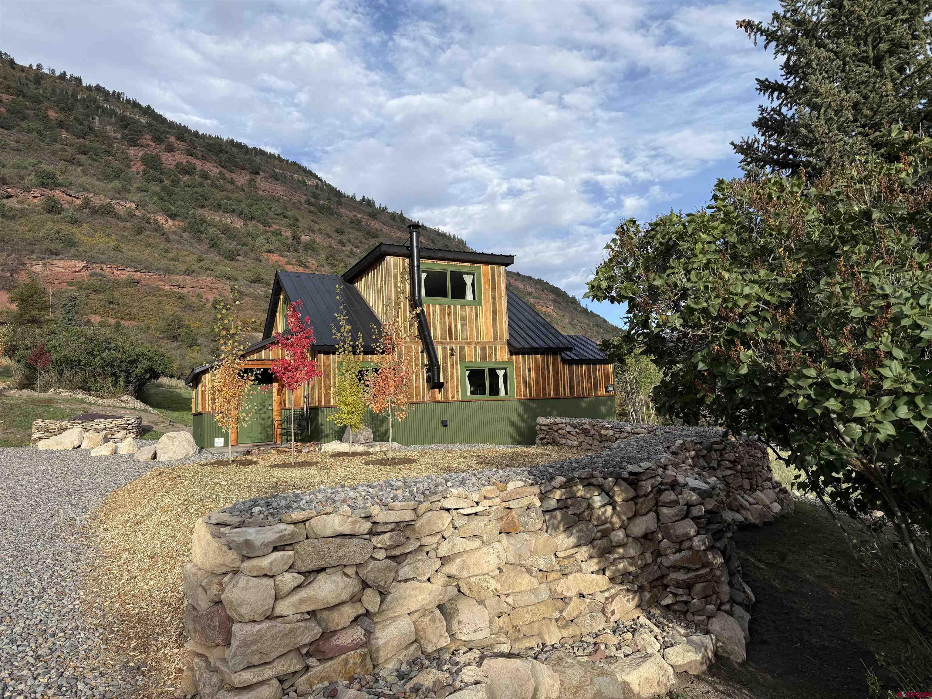 Welcome to your dream cottage in the Idlewild Estates at the entry of the Ouray Valley into the breathtaking San Juan mountain region 7500 feet altitude, large Ponderosa Pines aspens oak trees, running water with water rights. Charming new construction fully restored hand, brushed Barn-wood lodge, exterior with meticulously groomed, landscaping with beautiful views of mountains, deer, turkey, foxes, all wildlife… Charming full one bedroom with bath with walk-in closet area with full kitchen, laundry all new appliances. The house provides a serene retreat with plenty of natural light.Beautiful back deck,with fireplace. Enjoy morning, coffee and breakfast outside soaking in the Panoramic, Mountain View, and wildlife. Idlewild Estates offers perfect blend of seclusion, and convenience with easy access to local admin ties and  outdoor adventures. Plenty of room to build a main home , And grow the property ,Also a 100-year-old fully restored cabin within walking distance of the cottage. The adjacent 2 acres is potentially available making a 5+ acre parcel.