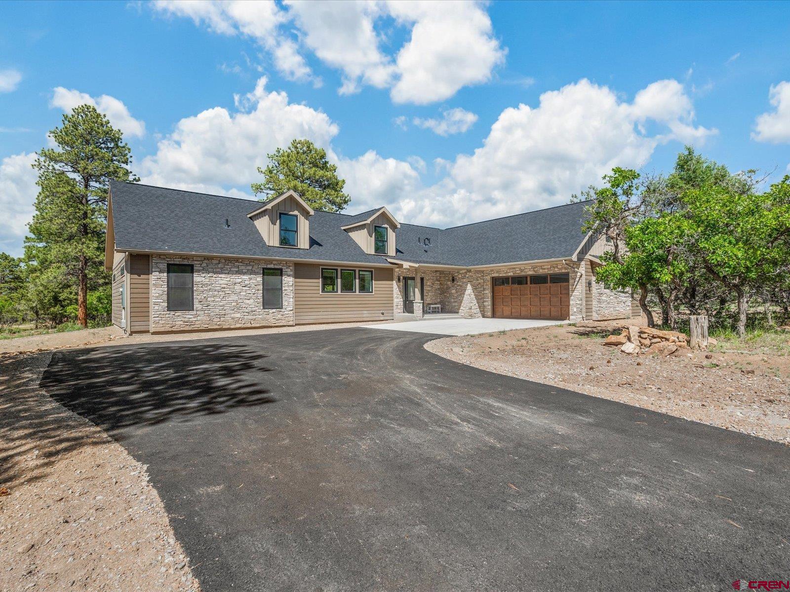 Brand New and Elevated Mountain Luxury Home On 1 Acre Bordering Golf Course with Fabulous Finishes! Every detail in this home has been dialed to perfection from beginning to end. Sharp curb appeal is heightened by dormer windows, a side entry garage, and a beautiful, Colorado-inspired stone and LP smartlap siding combination, which is also framed by towering pine trees creating a gorgeous and private alpine experience. Step inside to contemporary custom craftsmanship like you've never seen, accented by brilliant natural light streaming through all angles of this inspiring masterpiece. Gaze through the inviting, open-concept floor plan through 10' sliding glass doors featuring an enchanting Colorado forest backdrop. Epitomize the art of entertaining with multiple living and dining areas, complimented by an additional bar and sink in the oversized dining room. The main event could be the exquisite chef's kitchen, boasting a 55 cubic commercial-style stainless fridge, a 40 sq. ft island with top-notch quartz countertops, and a shocking amount of counter space. It doesn't stop there with an oversized farm sink, 2 independently mounted wall ovens, a huge oven, and large pantry! The main en-suite is something out of a dream with a massive walk-in shower with beautiful tile, and a large walk-in closet. This space also delivers uncompromising views and extra space, which could be utilized as the perfect spot for your morning yoga routine. Your loved ones will enjoy their own slice of indulgence in the guest suite, which is well-equipped with a tiled walk-in shower and closet, all located in a well-designed floor plan for privacy. As you head upstairs you will find that this custom home keeps on delivering fabulous feature after feature with an incredible game/family room space, 2 additional bedrooms, another full bathroom, and a hidden bonus room which could be the perfect home office or workout space. In what can only be described as the ultimate outdoor base camp, you will find unmatched recreation opportunities in every direction. Spend your summers on a jaw-dropping golf course with breathtaking views of the San Juans, and your winters snowshoeing and cross-country skiing. Enjoy additional year-round activities such as world-renowned mountain biking and gold medal fishing, all with the convenience of world-class healthcare and airport service in nearby Montrose. A Serene Dream of Elevated Mountain Euphoria is Waiting; What Are You Waiting For?