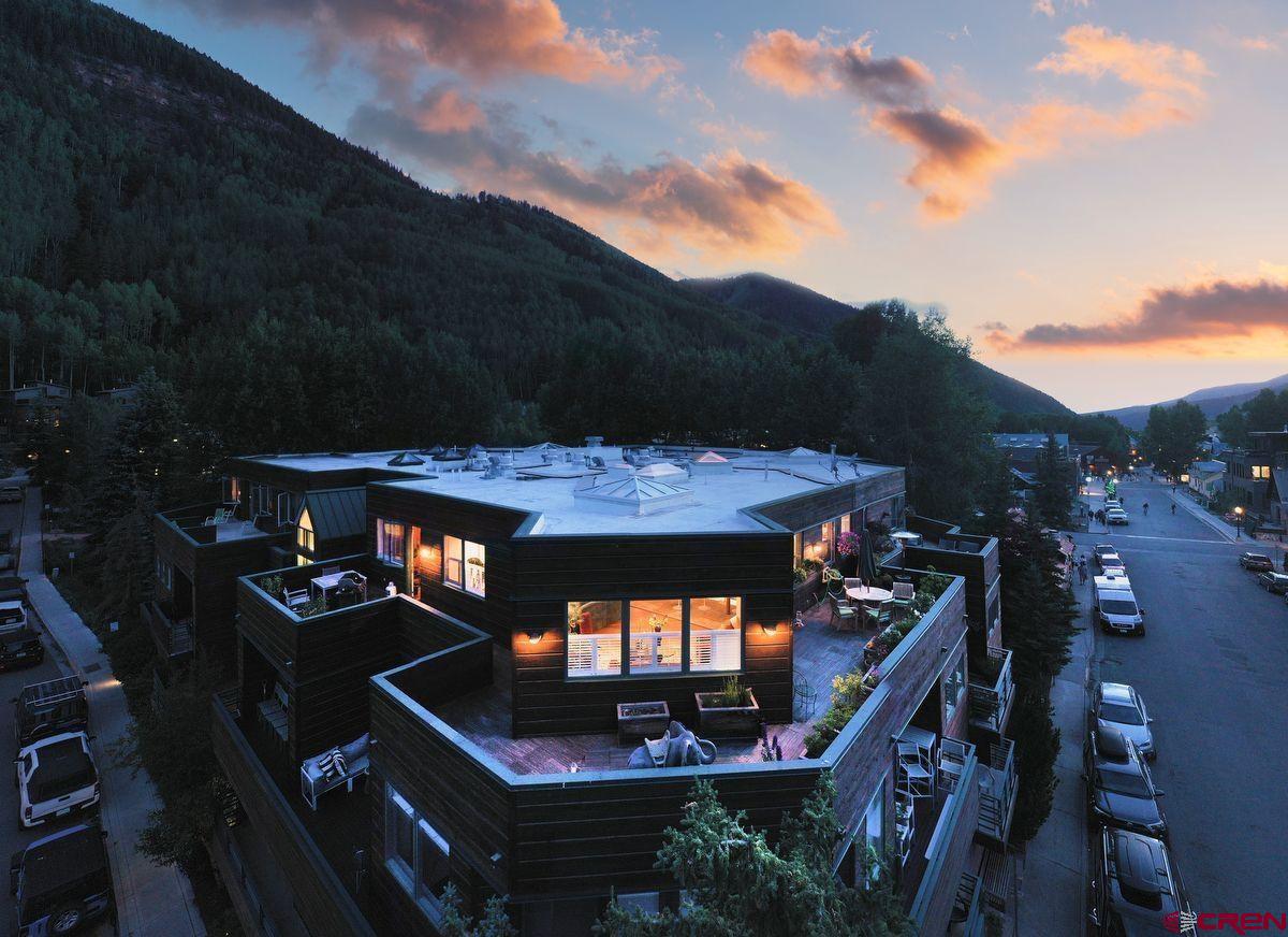 One of the most convenient locations in downtown Telluride. Located steps from skiing, the Gondola, numerous restaurants, and just two blocks from Main Street, the Ice House sits close to the Bear Creek hiking trail and provides a short, flat walk to skiing. The developer's personal residence offers unspoiled box canyon views from East to West from the wrap-around deck, not to mention the front-row seat for Telluride's famous firework show! The complex's amenities include a heated garage, private ski lockers, steam sauna, hot tub, heated indoor/outdoor pool, and elevator access. This single-level 2-bedroom, 2-bath penthouse enjoys ample natural light and features a gourmet kitchen. Enjoy seamless access from the living room to the deck, where you can take in the stunning surroundings.