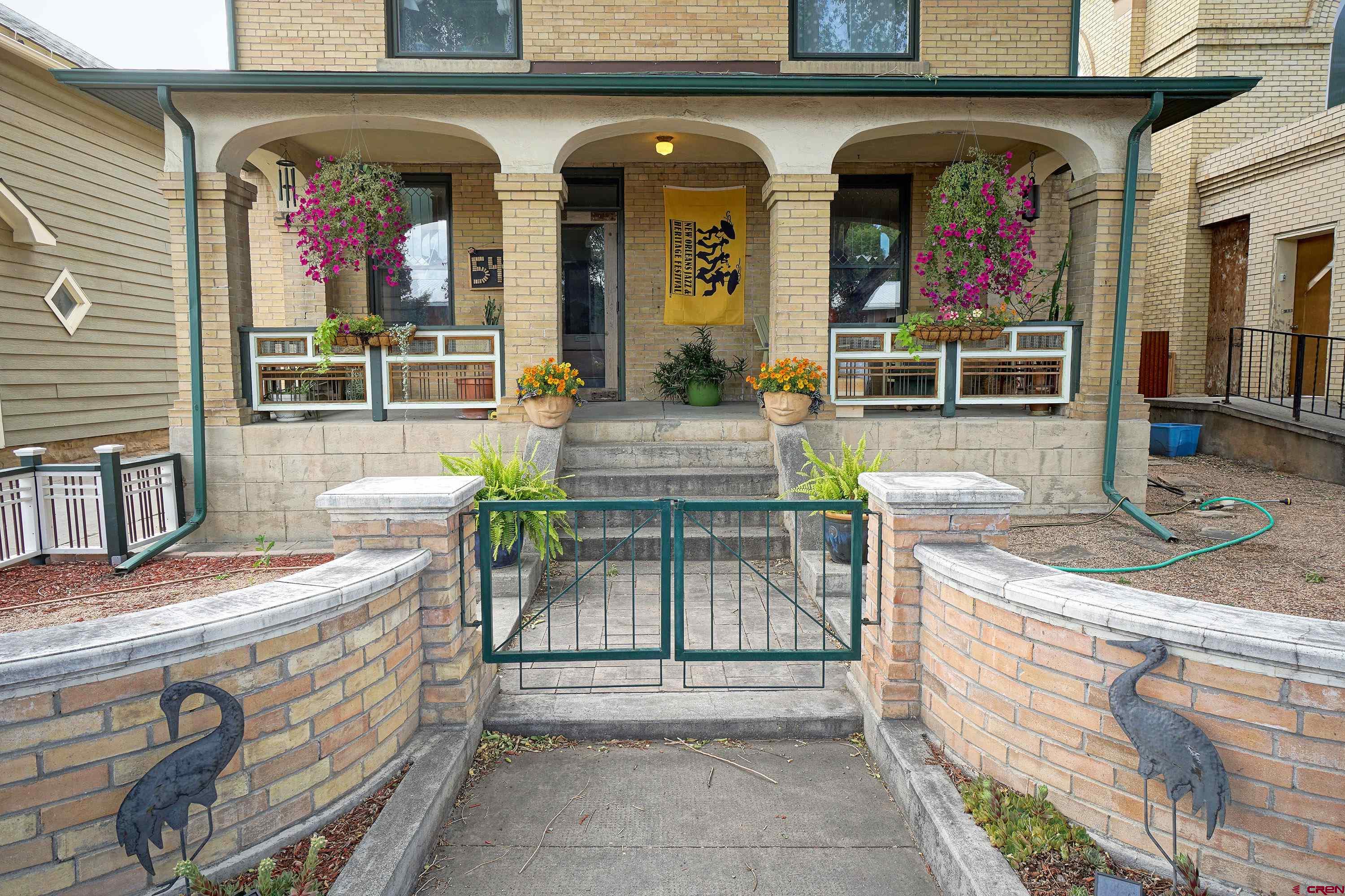 Come Experience this Historic Iconic Montrose, Colorado Home!  What does the City of Montrose, Colorado, mean to you? For many, it's the ideal blend of staying local while having the flexibility to explore anywhere. With a temperate climate, Montrose boasts milder summers compared to other parts of the country and winters that feel like a blessing. This inviting environment, along with outstanding air service (both commercial and private) and top-notch medical facilities, draws people to Montrose. Over the past 150 years, individuals have found their unique reasons to call Montrose home. This classic estate home stands as a testament to the charm that has attracted residents to Western Colorado. Two Homes, One Exceptional Property  Situated on a fully developed 6,250 square foot lot, this property includes a stately 3,300 square foot manor, fully remodeled, and a charming guest cottage that has become one of the area's most desirable Airbnb experiences. Every square foot of the lot has been thoughtfully enhanced and lovingly maintained.  A Historic Estate in Montrose  This home is one of the few remarkable properties in the area, joining the ranks of notable buildings like the KP Building (soon to be a boutique hotel), the Townsend Home, the Potato Growers building, the Masonic Temple, and the Methodist Church. Constructed in the year 1900, this "Turn of the Century" home offers a rare glimpse into the past, complete with a carriage house and horse-and-buggy tie-off out front.  The Main Manor  The main home spans three levels of approximately 1,000 square feet each, fully restored with elegant trim, soaring ceilings, oversized windows, and hardwood floors. The rooms are generously sized, showcasing intricate woodwork, tile, and trim, alongside modern fixtures, utilities, and appliances. This is a home where you can always discover something new and special. Upon entering, the intricately designed front yard and porch lead you into a regal entry area with views of the upper level, the kitchen core, and the beautiful parlor and dining room. The kitchen, with its granite counters, top-notch cabinetry, and spacious layout, serves as a true heart of the home. Beyond the kitchen, you'll find a laundry and specialty room that leads to the beautifully landscaped backyard. The lower level, accessible from the side yard, offers additional housing opportunities with an open layout, perfect for guests or family members, and even as an income stream. The bathroom and fireplace on this level ensure a cozy and comfortable atmosphere. The upper level features three oversized bedrooms, a full bath, and a luxurious master suite with a large walk-in closet, elegant soaking tub, and oversized tiled shower.  The Guest Cottage  The backyard, designed for relaxation and gatherings, is shielded from the late-day sun and features beautiful paths, stone walls, and a lovely greenhouse for both plants and projects. The former carriage house has been converted into a two-level ADU with two bedrooms, an inviting bath, and soaring ceilings. This space can serve as an office, guest home, workout studio, or income-generating rental.  Experience Montrose's Rich History  Are you searching for something special? Something that celebrates the rich history and charm of Montrose and Western Colorado? Come see this elegantly designed and fully restored home and become the next part of its legacy in Montrose.