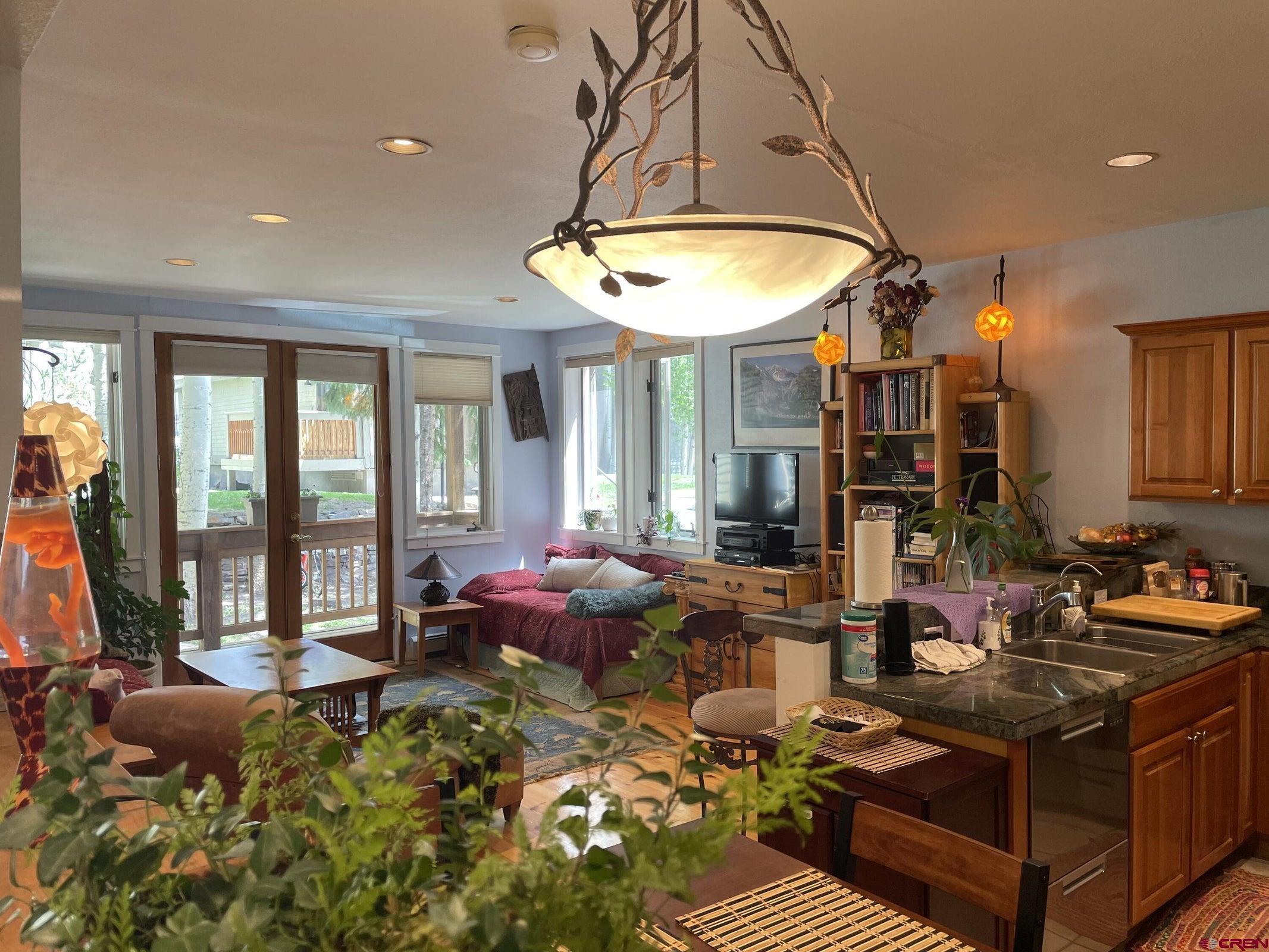 A spacious true two-bedroom two-bath one level unit in the Columbia Building of Tomboy Lodge has granite countertops, a large pantry and full-size stainless steel appliances in the kitchen and laundry. Features include hardwood flooring in the living room and tile in the kitchen, entryway and bathrooms; extra high ceilings in the living room and kitchen; gas heating, gas oven/range and BBQ grill. (Gas and hot water are included building amenites paid for by HOA dues). The large master bedroom has a walk-in closet with built-ins and an en-suite bathroom with a steam shower and tub. This unit includes three decks: one west-facing off the master bedroom, one off the second bedroom and a third at the gated entry of the living room. (See Addendum attached)