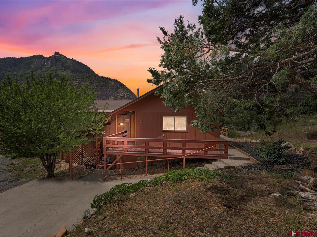 Perched above the City of Ouray this home has some outstanding views.   You get a different view from each side of the home.  It has 2,070 square feet with two bedrooms and two baths, large living room and a good sized kitchen and pantry.  There is a wood burning fireplace in the primary bedroom and a wood stove in the living room.  Just outside the door to the primary bedroom is a very nice hot tub with a new cover.  Two levels, each having a bedroom and a bathroom with the top level also housing the kitchen, living room and large deck.  The deck is absolutely lovely.  Such a tranquil setting surrounded by the towering mountains and overlooking the town.  This home is on a very large lot for Ouray, 12,527 feet.  Easy access to Hwy 550 and the town.  Walkable to everything in town, yet just high enough to enjoy the views without all the tourist traffic in the summer months.