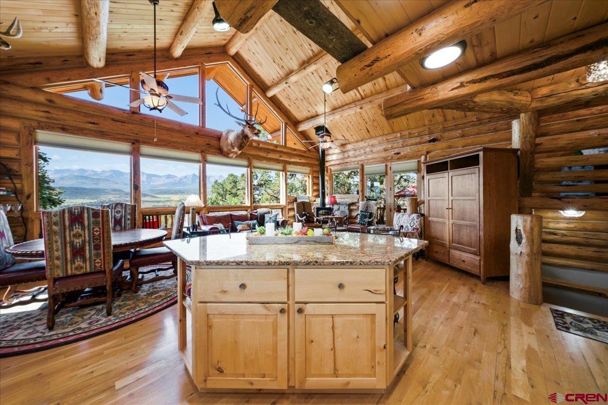 Every once in a while a house comes along and you say, “This is something special”. This is that house. Sitting in the heart of Pleasant Valley, this Frontier log masterpiece is the epitome of Colorado mountain living, summer and winter, with its panoramic views from the Cimarrons to the San Juans, lush green pastures on the valley floor, quiet, and privacy,  If the view wasn’t enough, once you step through the door you immediately feel the warmth and comfort that is so much a part of this home. The main floor encompasses the ever popular open floorplan with the great room, kitchen, dining area, the guest bedroom and bath plus the laundry room. Circled in windows, the natural light is amazing. The logs, the beams and decking, the wood floors all invite you to sit down, put your feet up and know that while the world seems to be spinning out of control, this is a special space, and all is well. Up the log staircase you will find a loft area that would make a perfect office space. You may not be able to get anything done, however, except look at the view. The master bedroom on this level is the definition of comfortable, as is the bath. The lower level is a fabulous entertainment area with a half bath adjacent and direct access to a one car garage that could easily be converted to a third bedroom if need be. The hot tub is right outside the door! And the garage! Three large bays, 1,058 square feet, plenty of work area and heated. There is a 420 square foot finished room above the garage with spectacular views to the south. This could be a studio, home office or more storage than you would ever need.  If a move to the mountains of Colorado and all that lifestyle has to offer is on your horizon, then  don’t miss the opportunity to see this exceptional home and its unmatched setting.
