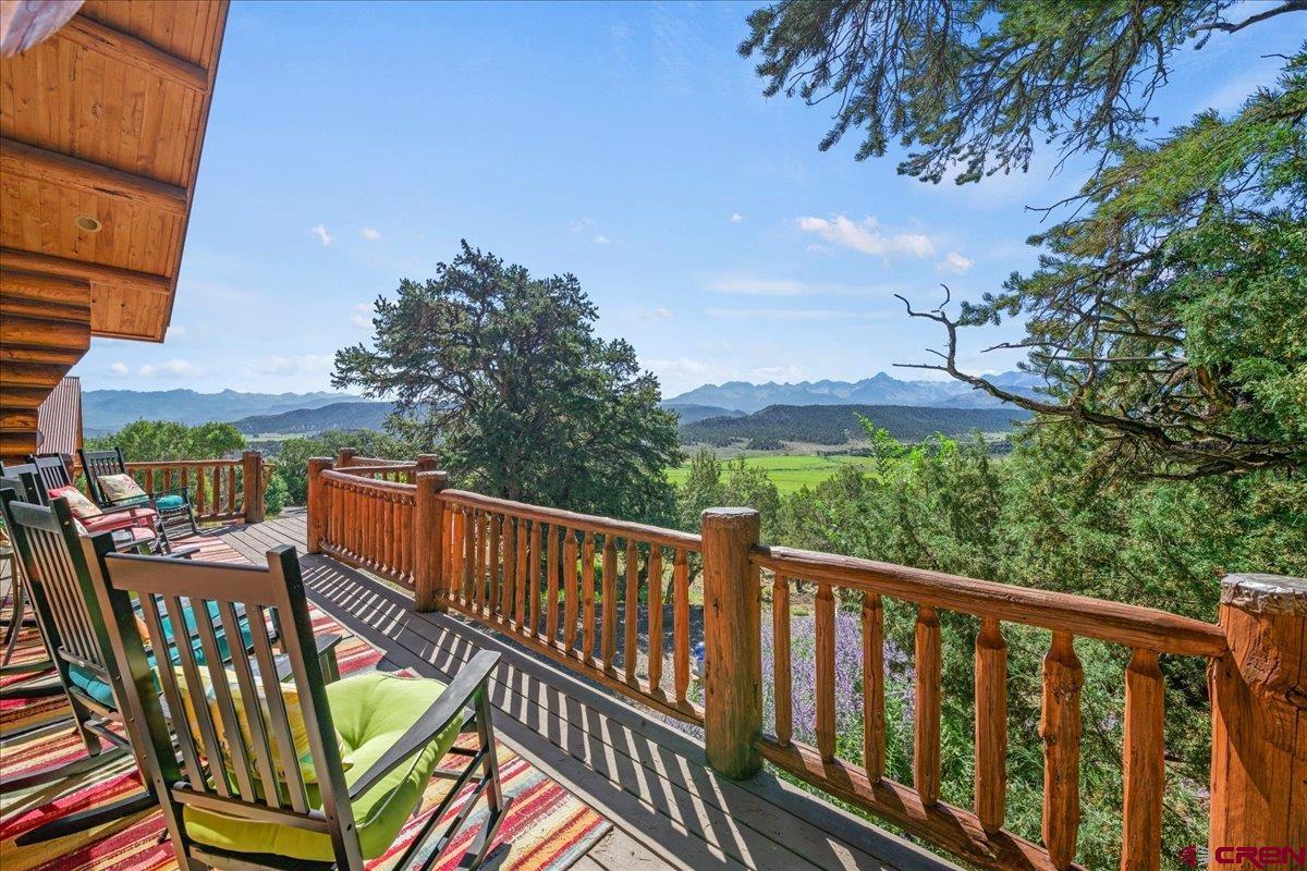 Every once in a while a house comes along and you say, “This is something special”. This is that house. Sitting in the heart of Pleasant Valley, this Frontier log masterpiece is the epitome of Colorado mountain living, summer and winter, with its panoramic views from the Cimarrons to the San Juans, lush green pastures on the valley floor, quiet, and privacy,  If the view wasn’t enough, once you step through the door you immediately feel the warmth and comfort that is so much a part of this home. The main floor encompasses the ever popular open floorplan with the great room, kitchen, dining area, the guest bedroom and bath plus the laundry room. Circled in windows, the natural light is amazing. The logs, the beams and decking, the wood floors all invite you to sit down, put your feet up and know that while the world seems to be spinning out of control, this is a special space, and all is well. Up the log staircase you will find a loft area that would make a perfect office space. You may not be able to get anything done, however, except look at the view. The master bedroom on this level is the definition of comfortable, as is the bath. The lower level is a fabulous entertainment area with a half bath adjacent and direct access to a one car garage that could easily be converted to a third bedroom if need be. The hot tub is right outside the door! And the garage! Three large bays, 1,058 square feet, plenty of work area and heated. There is a 420 square foot finished room above the garage with spectacular views to the south. This could be a studio, home office or more storage than you would ever need.  If a move to the mountains of Colorado and all that lifestyle has to offer is on your horizon, then  don’t miss the opportunity to see this exceptional home and its unmatched setting.