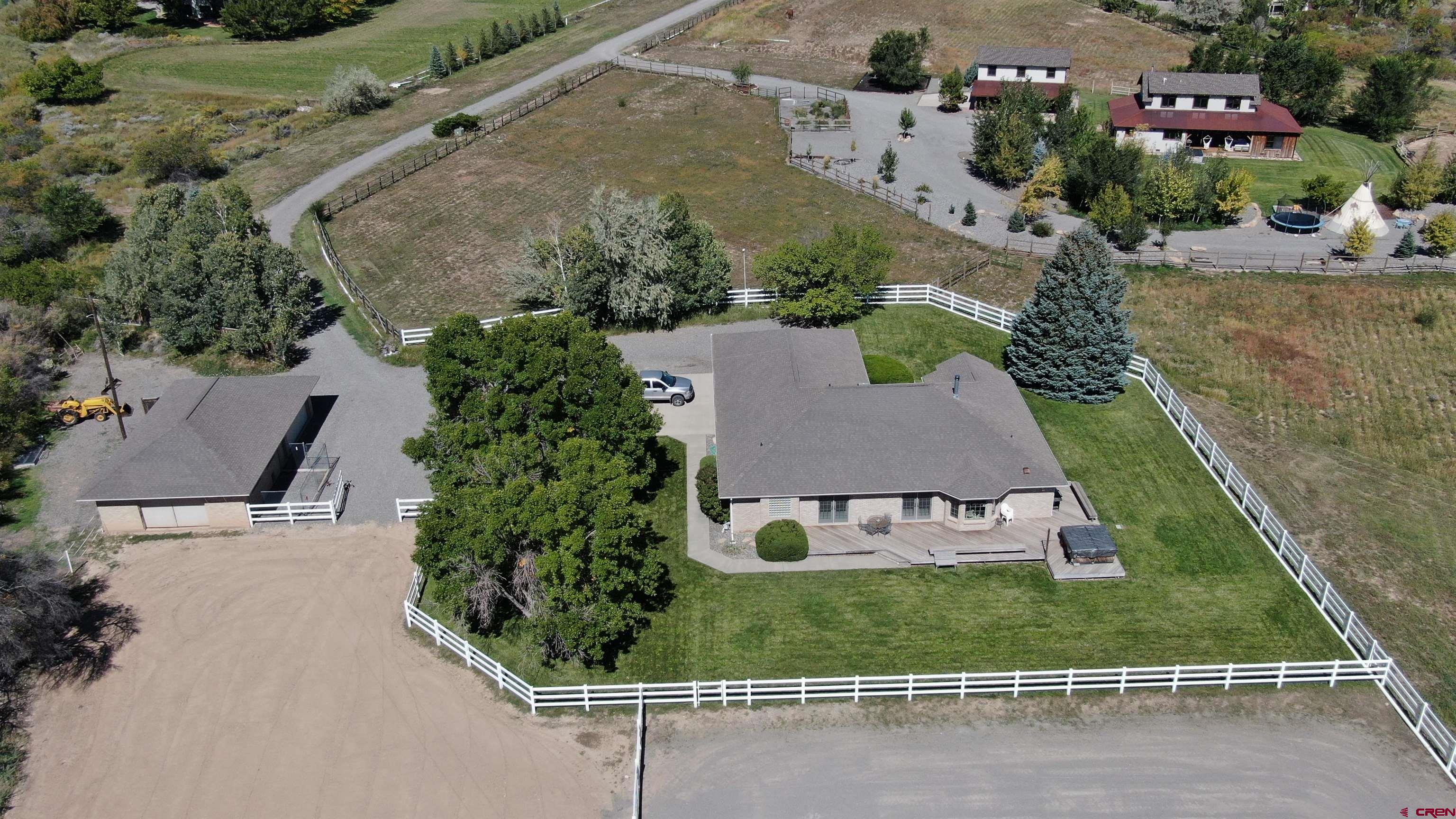 It is rare in this area, or any area for that matter, to find a property like this! Location! Location! Views! Views! 6.09 Acres with 5.4 shares of U.V.W.U.A irrigation water piped underground to pasture and lawn sprinkler systems. The property is located adjacent to Spring Creek Mesa escarpment. Views! Views! All Brick 2,335 sq. ft. single story ranch style home with a 1,070 sq. ft. partially finished basement that includes a finished Rec Room with space for game tables & storage. The main floor has 3 bedrooms, 2 baths, and a spacious office/den with built in cabinets and wrap-around work surfaces. The kitchen has a spacious pantry wall and opens into the family room with a custom wood burning fireplace. Enjoy the bay window eating nook and French doors that open onto a wrap-around deck from both the family room and master bedroom with expansive views of the San Juans. Off the kitchen is a formal dining room with adjacent living room that has a cathedral ceiling and windows galore. The home is attached to an oversized 3 car garage.  Outside is a beautiful landscaped yard w/ trees, bushes, flowers, and several apricot trees. The detached 26ft x 44ft all brick garage/horse barn has an additional 2 car garage bay large enough for an oversized pickup and a boat. There is a "horse tack" wall with saddle racks and blanket and bridle hanging rods. The barn/garage includes a hay storage bay with an additional garage door opening and an enclosed 4 horse stall area with sliding stall doors and feeder doors. Large sliding barn doors open to a fenced paddock and a large separate fenced riding arena that has several inches of "belt-sand" surface. There is a spacious & fenced dog run opening into an oversized indoor dog house. This property sits at the end of a county road cul-de-sac down an owned private drive.  Views! Views! Want More? Seller will include a small Massey Ferguson tractor with front end loader and 3 implements!