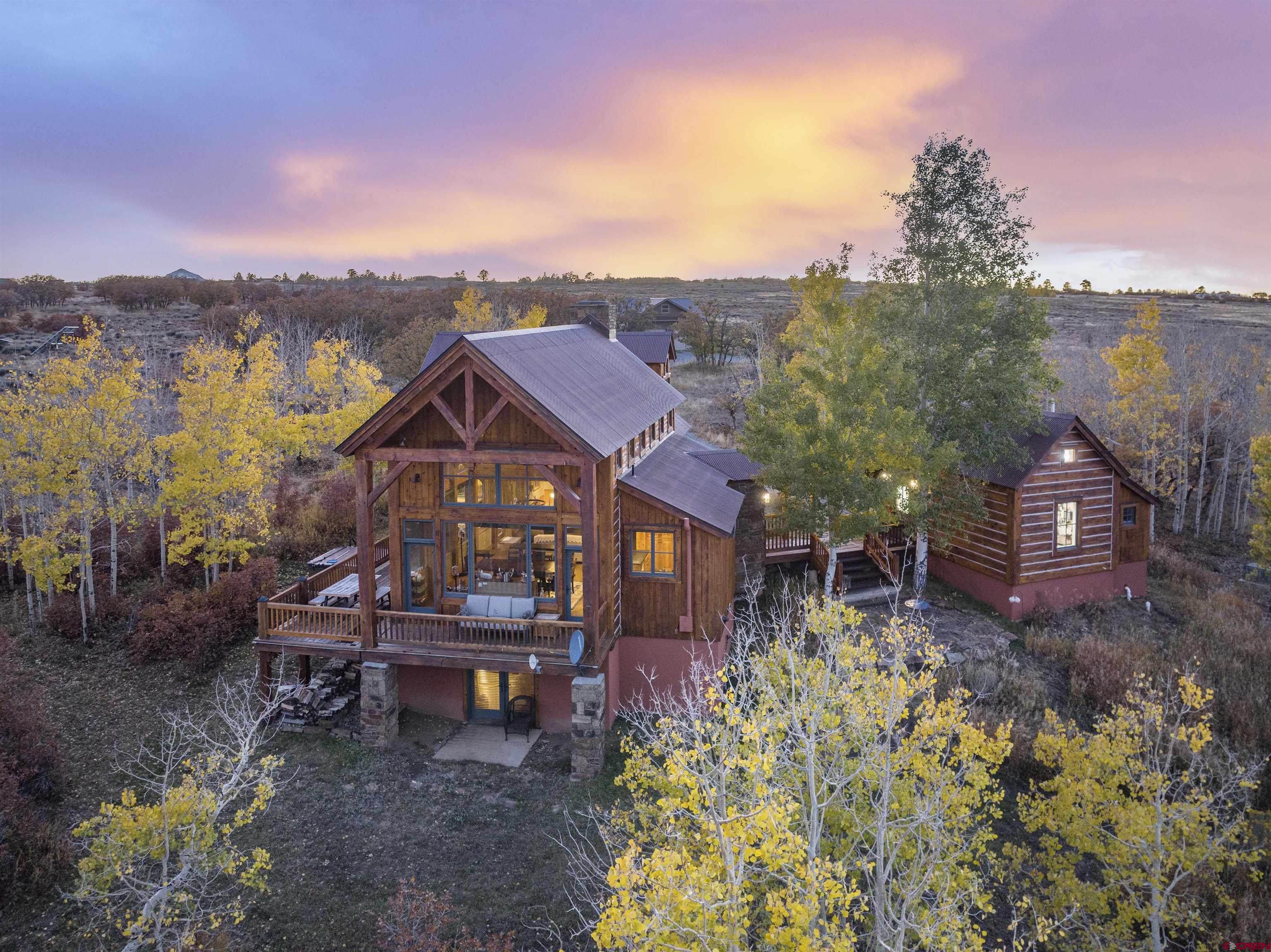 ''Mountain Sky'' at 1036 Harcourt Trail is a charming timber-frame refuge located just 25 minutes from the Historic Town of Telluride. This rustic retreat is set on 54 gently sloping acres with a diverse array of mature trees and magnificent views. The primary living space features two-story windows that provide mesmerizing vistas and abundant natural light to an open floor plan with a cozy wood burning fireplace. The main house offers three bedrooms as currently configured, with the primary suite and loft located on the upper level, a second bedroom and bunk room both located on the ground floor, and a spacious flex room on the garden level. Attached to the main house via breezeway is a separate, finished workshop equipped with bathroom and shower ... and completing your ideal mountain escape is a detached two-and-a-half car garage with ample second-floor storage.