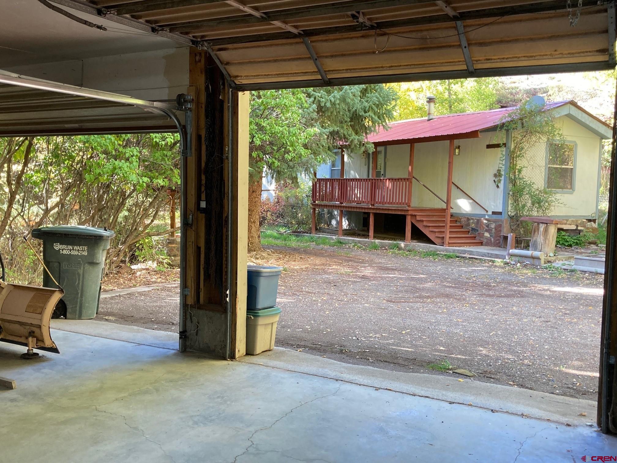 Affordable Mountain Living Just Minutes from Ouray Looking for an affordable home base in Ouray County that gives you space to work on your projects and quick access to the great outdoors? This nearly 2-acre property sits just outside the town limits of Ouray—close enough to enjoy the restaurants, shops, and hot springs, yet tucked away with room to spread out. The property includes a comfortable two-bedroom, two-bath mobile home with a metal roof and covered porch—move-in ready and perfect as a year-round residence, part-time retreat, or temporary home while you plan a future build. You’ll appreciate the rare benefit of full Town of Ouray water and sewer service, along with power and natural gas already in place. For anyone who needs space to work, the 25’ x 35’ insulated workshop is a huge bonus. With a solid slab foundation and upper-level storage, it’s ideal for projects, equipment, tools, or storing all your mountain gear. Outdoors, you’ll enjoy a wide, level lawn framed by fruit trees and evergreens, plus a wooded hillside that adds privacy and a true mountain feel. From here, you’re only minutes to world-class hiking trails, jeep routes, and hunting areas—everything that makes Ouray County one of Colorado’s most sought-after adventure hubs. Whether you want a simple and affordable place to call home, a workshop with extra acreage, or a property with potential to grow, this unique offering checks all the boxes. Come see it for yourself and imagine the possibilities.