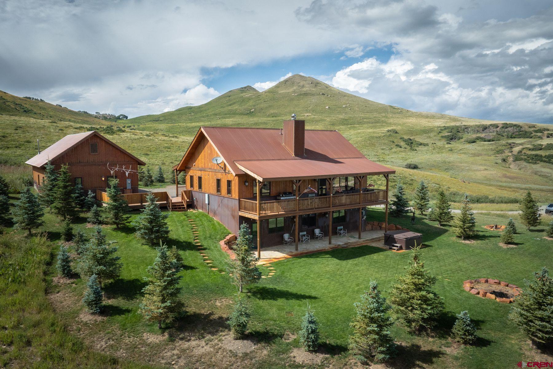 For those seeking a serene, alpine retreat where the intrusions of the outside world are easily held at bay. Still water, aspen forests, and big skies abound. After supper, take the stroll to one of the stocked ponds on the 99+ acres to practice your fly casting, anchoring your thoughts in the present moment, distractions melting away. Retire to the deck to marvel at the ever changing light on the unique peaks and ridges of the Cimarron. A properly-sized home, built to exacting standards in 2019, features 3 bedrooms and 2 full baths, while the 900 sq ft garage is squeaky clean and already plumbed. The lush landscaping around the home features many native trees and a level yard. Eliminate the headaches of building - step into a turnkey opportunity and start making those memories today.