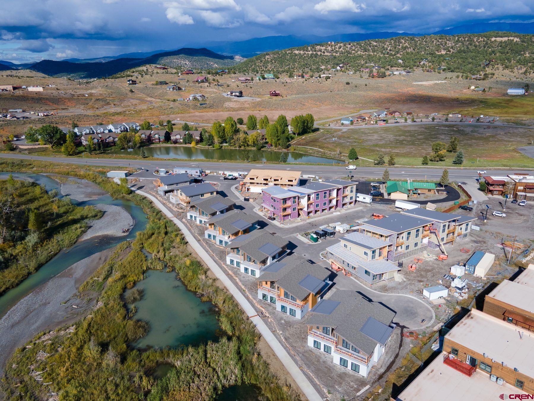 TO BE BUILT Currently under construction with completion date and Certificate of Occupancy scheduled for August 1, 2025.  Perfectly situated as the only Ridgway residential project on the Uncompahgre River, Riverfront Village offers quick highway access to Telluride, Ouray, Silverton, and Montrose while a stroll down the river trail leads to downtown shops and restaurants.  Take advantage of early pricing in this opening release! This unit has huge direct Box Canyon views into Ouray, a two-plus car garage, Air Conditioning, south south-facing deck, only one shared wall, and is located on the second floor. The property is a construction site and all tours must be with a RRV Team member.  Some photos of this listing may include virtually staged amenities, furniture or fixtures. Some actual photos are of our model unit representing the finishes planned.