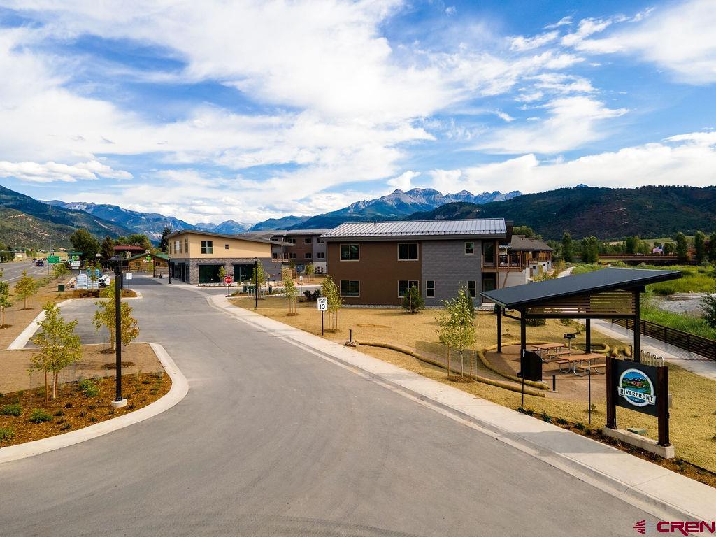 TO BE BUILT Currently under construction with completion date and Certificate of Occupancy scheduled for end of August, 2025.  Perfectly situated as the only Ridgway residential project on the Uncompahgre River, Riverfront Village offers quick highway access to Telluride, Ouray, Silverton, and Montrose while a stroll down the river trail leads to downtown shops and restaurants.  Take advantage of early pricing in this opening release! This unit has huge direct Box Canyon views into Ouray, a two-plus car garage, Air Conditioning, south south-facing deck, only one shared wall, and is located on the second floor. The property is a construction site and all tours must be with a RRV Team member.  Some photos of this listing may include virtually staged amenities, furniture or fixtures. Some actual photos are of our model unit representing the finishes planned.  There are other units available that are not currently listed in the MLS, please inquire about additional opportunities.