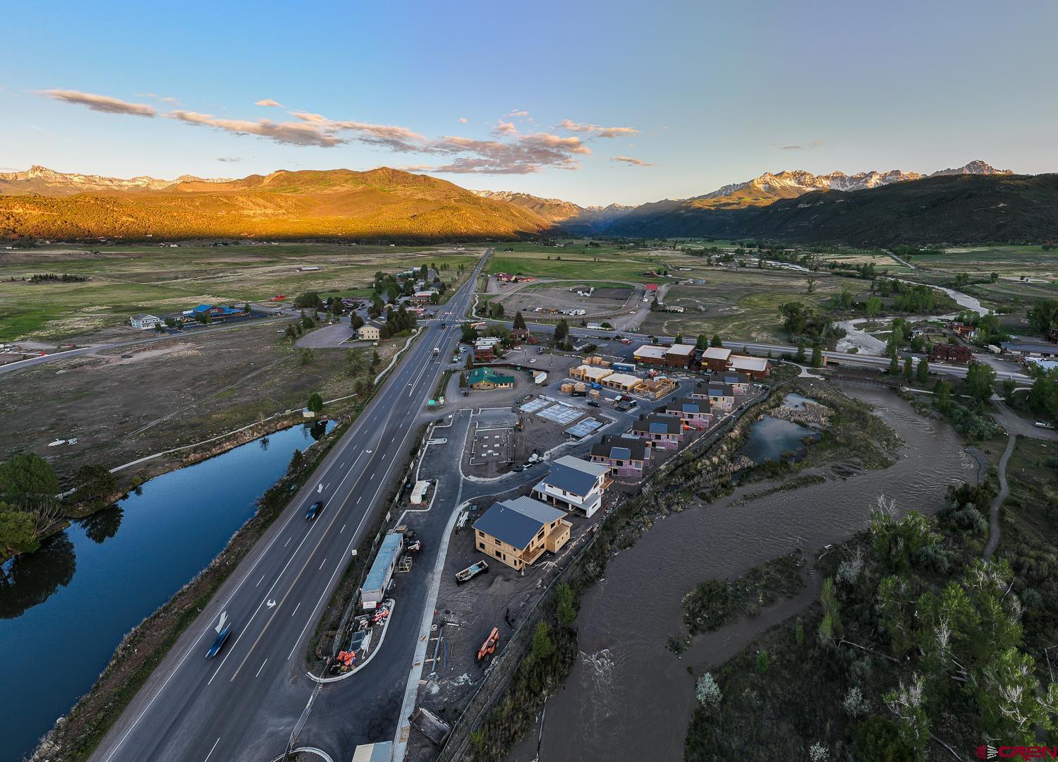 Perfectly situated as the only Ridgway residential project on the Uncompahgre River, Riverfront Village offers quick highway access to Telluride, Ouray, Silverton, and Montrose while a stroll down the river trail leads to downtown shops and restaurants. A certificate of occupancy for the 38-unit project is expected in July 2025. Take advantage of early pricing in this opening release! This unit has huge direct Box Canyon views into Ouray, a two-plus car garage, Air Conditioning, south south-facing deck, only one shared wall, and is located on the second floor. The property is a construction site and all tours must be with a RRV Team member.
