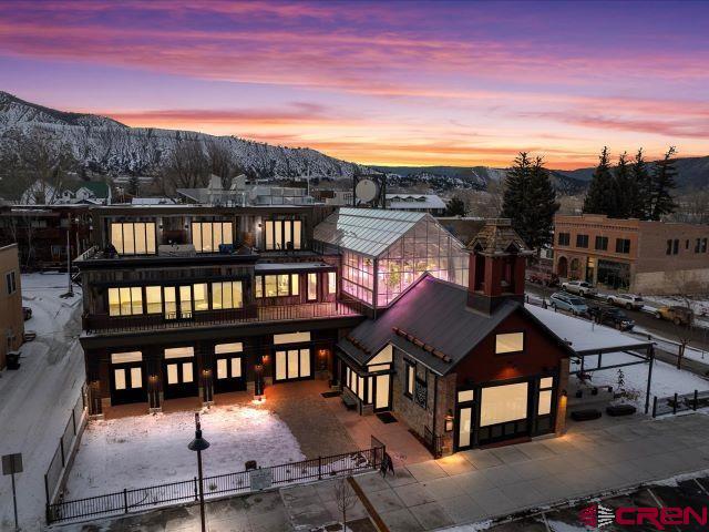 CONDO "E":  Fantastic brand new condo on the 3rd story of the Old Firehouse.  This is a very special unit given the location, views and size.  There is elevator access and a 2-car attached garage.  3 Bedroom/2 Bath with just a bit over 2026 sq. ft. of living space.  The primary bedroom is off by itself with a huge bath and closet area.  The other bedrooms have a shared bath.  The east facing balcony is over 670SF and private w/ a fireplace and snow melt deck.  The views from this unit are incredible of the town park, Sneffel's Range as well as the Cimarron Mountains and Ouray Valley.