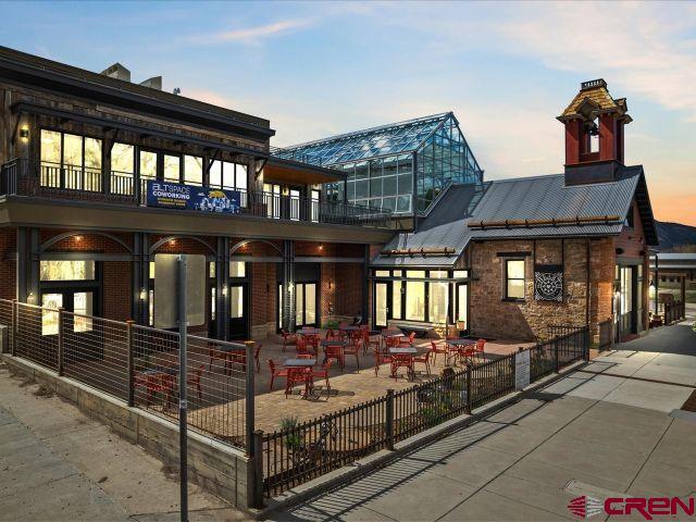 CONDO "E":  Fantastic brand new condo on the 3rd story of the Old Firehouse.  This is a very special unit given the location, views and size.  There is elevator access and a 2-car attached garage.  3 Bedroom/2 Bath with just a bit over 2026 sq. ft. of living space.  The primary bedroom is off by itself with a huge bath and closet area.  The other bedrooms have a shared bath.  The east facing balcony is over 670SF and private w/ a fireplace and snow melt deck.  The views from this unit are incredible of the town park, Sneffel's Range as well as the Cimarron Mountains and Ouray Valley.  Some photos of this listing may include virtually staged amenities, furniture or fixtures