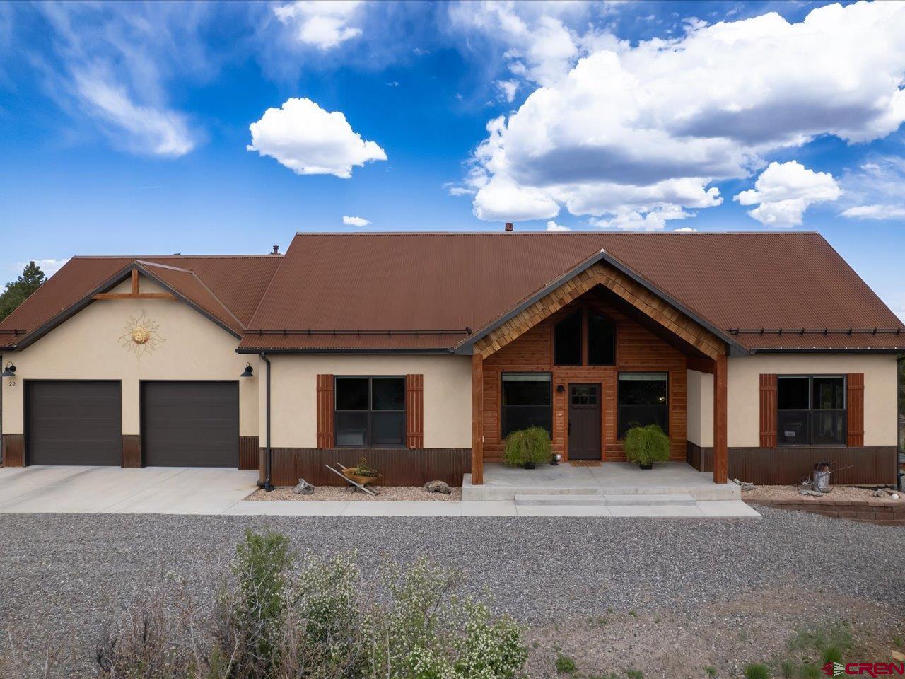 Simplistic elegance meets rustic charm in this gorgeous home completed in 2020 by local builder, Chris Sjoden, whose reputation is second to none.  Known for his mastercraftsman abilities and attention to detail, you will be dazzled by the quality of work in this well-thought-out home.  Feast your eyes on the incredible views of the Cimarron range from the covered front porch and step inside to a cozy great room with cathedral ceiling and gas stove.  The spectacular kitchen features steel countertops, custom crafted knotty alder cabinets, a breakfast bar and large pantry. From the dining room you can step out onto a large trex patio and enjoy views of the Cimarron range from here, too.  The generous master suite sits off to one side of the great room and has a charming walk-out private patio. The master bathroom is exquisite with a full-tiled walk-in shower, gorgeous soaking tub and beautiful dual sink vanity.  This home has a special feature that you won't find in many homes - the large laundry room features a custom built dog wash. The house includes all of the stainless steel kitchen appliances and the washer and dryer. Guys will be impressed with the oversized two car garage and don't miss the pull-down attic storage.  There's about 300 square feet of space up there that could be converted into livable square footage.  A radon mitigation system is already installed.  There's a drip system for watering plants, but it's not connected. A gas bib in place for adding a gas fire pit and the property has been mitigated for fire prevention.  There's also a peek-a-boo view of the iconic Mt. Sneffels. The orientation of this home allows for passive solar.  No A/C needed here.  Let the fresh air cool your home at night, close up the house in the morning and enjoy comfort all day. This home exudes charm and comfort and offers single level living with views, which isn't easy to find in Loghill Village.
