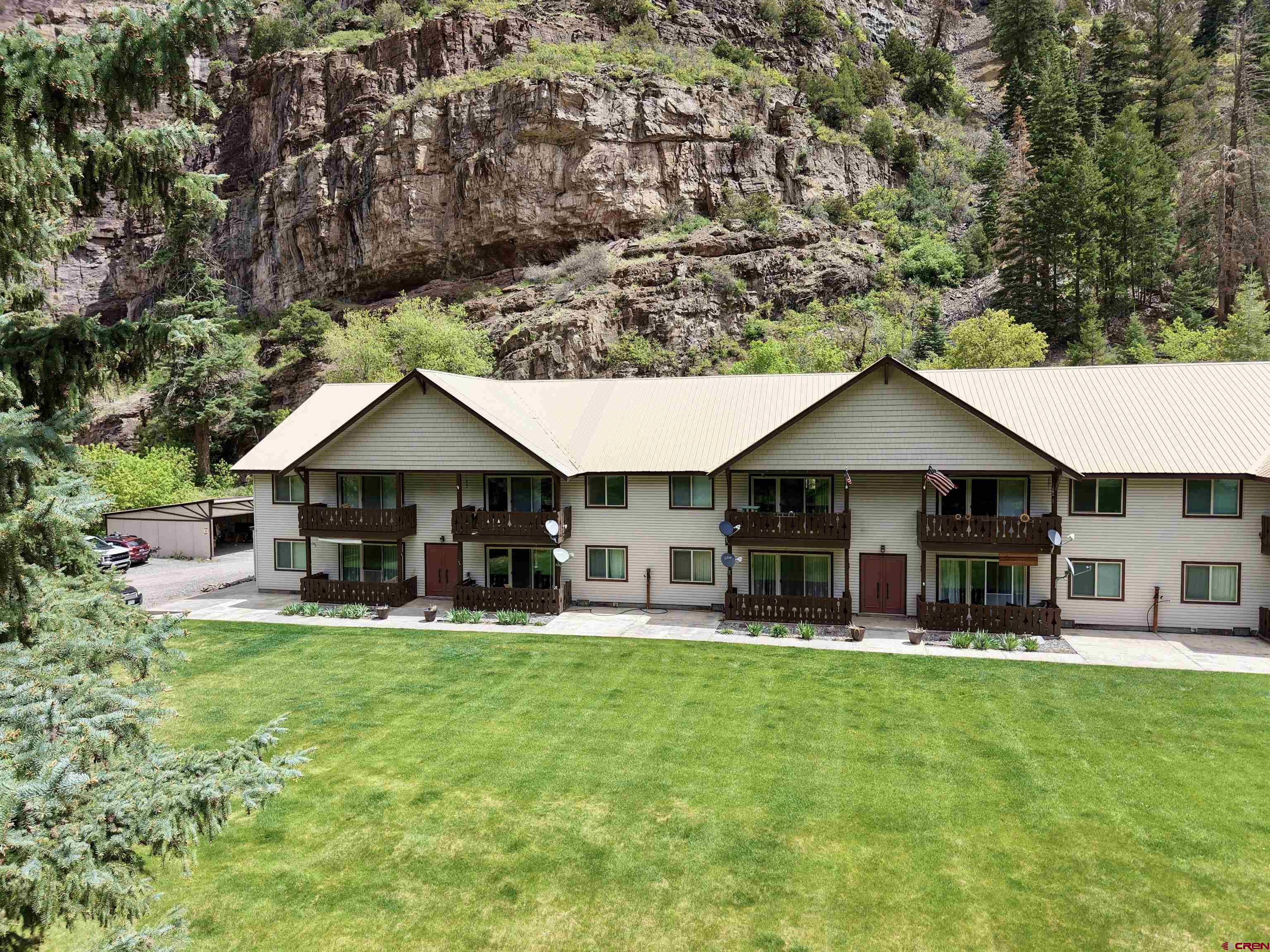 Take a look at this opportunity in the one and only Ouray, CO, known to many as the 'Switzerland of America'! Just a short distance down the road from the popular Ouray Hot Springs, along with all the shopping and eateries, this is truly a prime location. This clean and well-maintained 2-bedroom, 1-bathroom condo is on the ground level with no steps and easy access. There is covered parking with an additional storage space. All-new flooring was just professionally installed in November of 2024. When you visit, you'll note the fresh paint and new vanity as additional tasteful updates. The patio opens out to the large trees spread across the grass-covered common area...the perfect setting for summer gatherings, picnics, a workout, or to sit and admire the Bighorn sheep and other wildlife that also frequently enjoy the space. Whether your ideal use is as a primary residence, 2nd home, or investment property, the options are wide open, and you can focus on enjoying your time when here since the exterior maintenance, snow removal, lawn care, etc., is all taken care of for you! This is one you don't want to let get away...call today to schedule your private showing before it's gone!