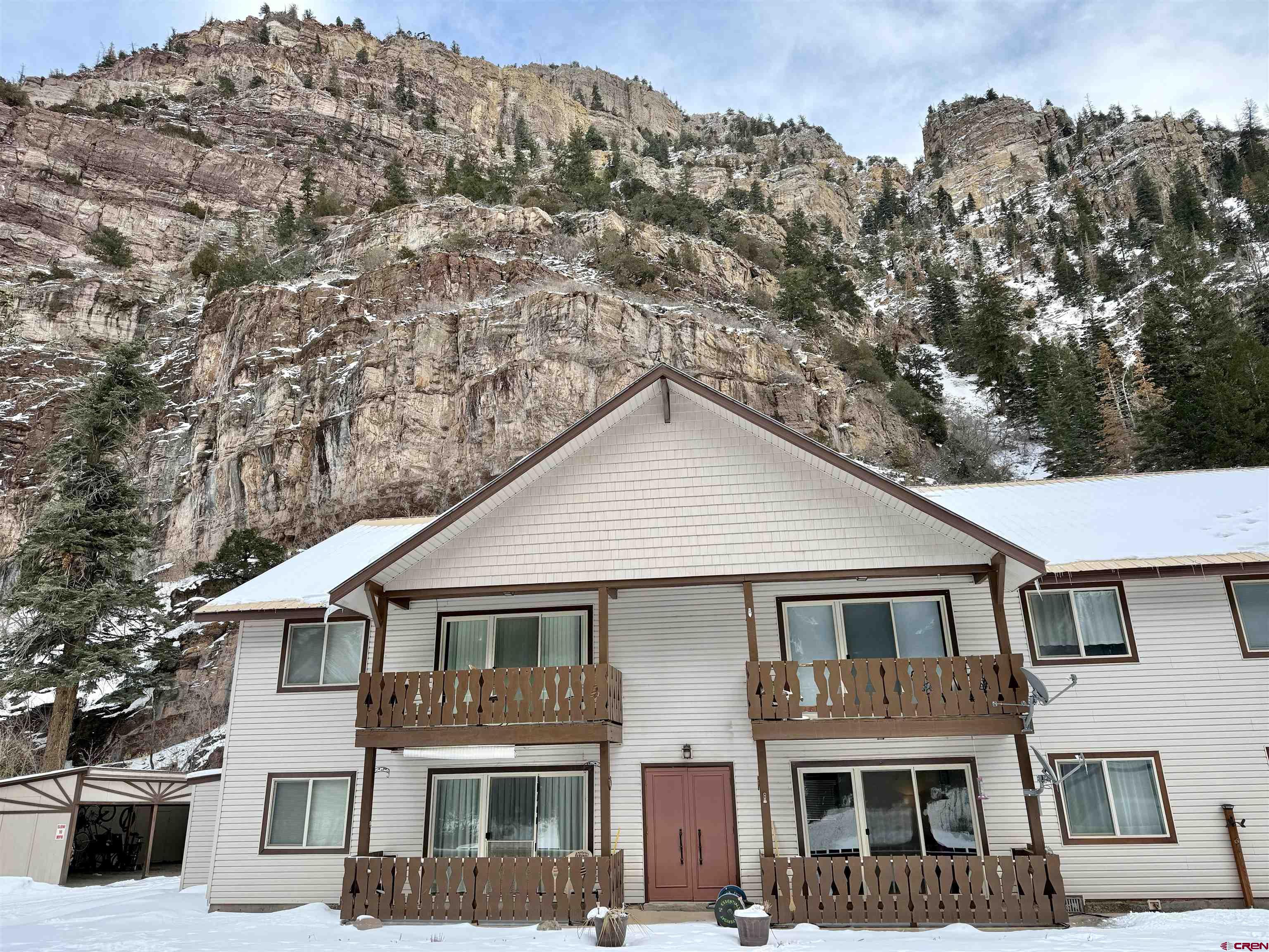 Take a look at this opportunity in the one and only Ouray, CO, known to many as the 'Switzerland of America'! Just a short distance down the road from the popular Ouray Hot Springs, along with all the shopping and eateries, this is truly a prime location. This clean and well-maintained 2-bedroom, 1-bathroom condo is on the ground level with no steps and easy access. There is covered parking with an additional storage space. All-new flooring was just professionally installed in November of 2024. When you visit, you'll note the fresh paint and new vanity as additional tasteful updates. The patio opens out to the large trees spread across the grass-covered common area...the perfect setting for summer gatherings, picnics, a workout, or to sit and admire the Bighorn sheep and other wildlife that also frequently enjoy the space. Whether your ideal use is as a primary residence, 2nd home, or investment property, the options are wide open, and you can focus on enjoying your time when here since the exterior maintenance, snow removal, lawn care, etc., is all taken care of for you! This is one you don't want to let get away...call today to schedule your private showing before it's gone!