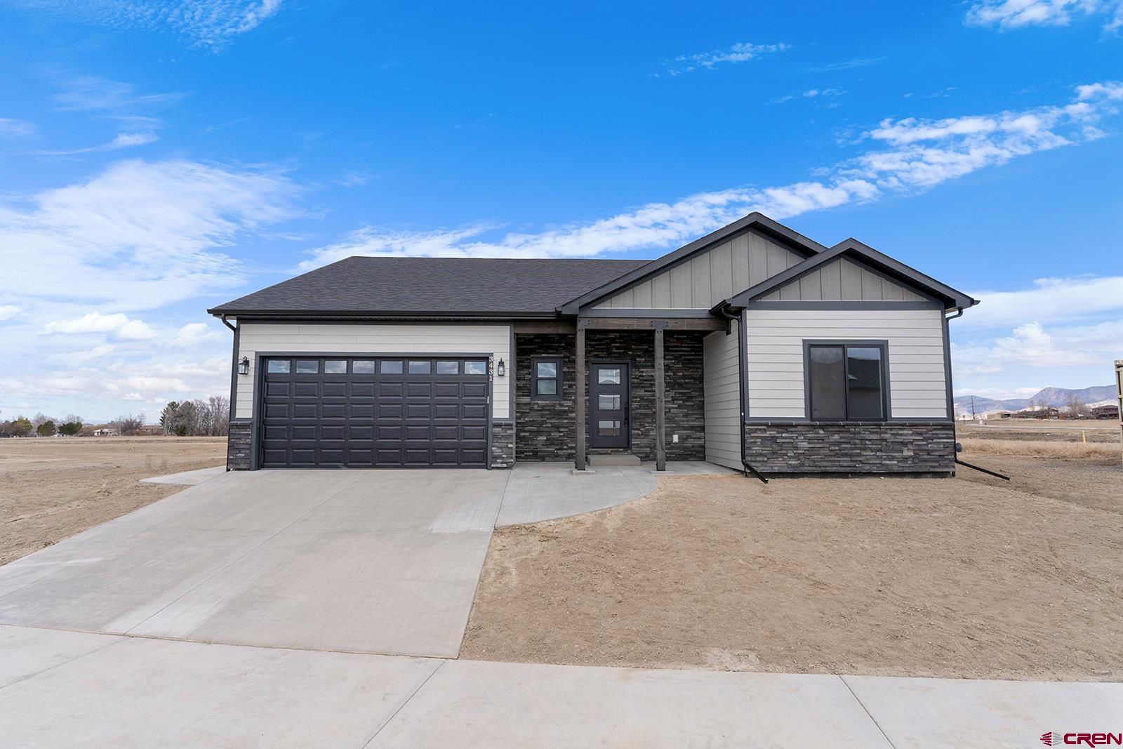 Brand New Home READY NOW built by Ridgeline Homes. Thoughtfully designed for effortless living all on one level, Ridgeline's Grand Teton 1808sf model features a split floor plan of 4 bedrooms and 2 baths with an elegant open-concept living space with vaulted ceiling, ceiling fan and gorgeous stone-accented gas fireplace with a beautiful wood mantel.  The living and dining room are open to the gourmet kitchen adorned with upgraded painted cabinetry with soft-close doors and drawers, taller upper cabinets, quartz counters, a stylish tiled backsplash, under-cabinet lighting, TWO pantries and a large kitchen island perfect for entertaining. A premium appliance package includes a stainless steel gas range/oven, refrigerator, dishwasher and microwave. The luxurious master suite boasts a vaulted ceiling with a ceiling fan, a beautifully tiled master shower with a sliding glass door, a separate bathtub, two sink vanity, private toilet, and a generous walk-in closet. Laundry room offers extra cabinets and countertop with washer and dryer also included plus there's tons of storage space with two large coat closets and hallway linen closet.  Extra space is also provided in the 2-car garage with one bay extended providing room for workout area, workshop, toys or storage.  Designed with energy efficiency in mind, this home includes forced air gas heating, central air conditioning, an on-demand hot water heater, and a radon mitigation system for peace of mind. Outdoor living is enhanced with a covered front porch and covered back patio, with extended concrete from the garage to the back patio for added convenience.  Added curb appeal with upgraded board and batten accent siding. Ask about Seller's preferred lender concessions. Don’t miss this incredible opportunity to own this brand-new home in beautiful Montrose before it's gone!  (Builder has other models and other lots available in Woods Crossing with prices starting at $469,000.)