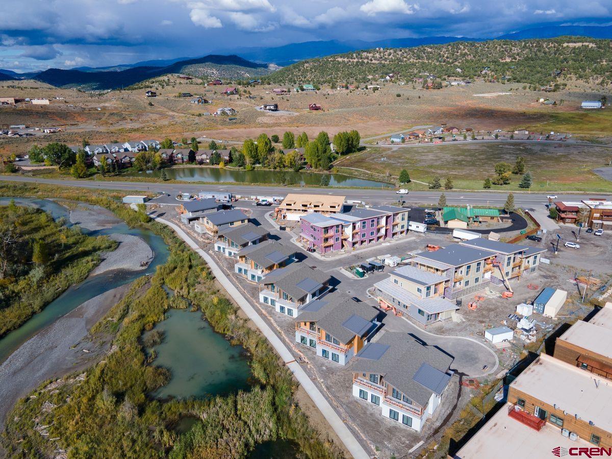 Placed in an ideal location along the banks of the Uncompahgre River, Riverfront Village offers the only riverfront residences in the town of Ridgway. Open space across the river brings privacy and tranquility to residents. These mountain modern condominiums and duplexes range from 2 to 3 bedrooms and include 2-car garages. They also boast alpenglow vistas to the east and evening sunsets dancing across the river to the west. Natural textures are complemented by warm, neutral accents for the perfect blend of polish and comfort. Walk, bike, or jog along the recreation path that leads from Riverfront Village to downtown dining and shopping options as well as Ridgway State Park and Ridgway Reservoir. Nestled in the Uncompahgre Valley ringed by the Cimarron Mountains, call Ridgway Home.