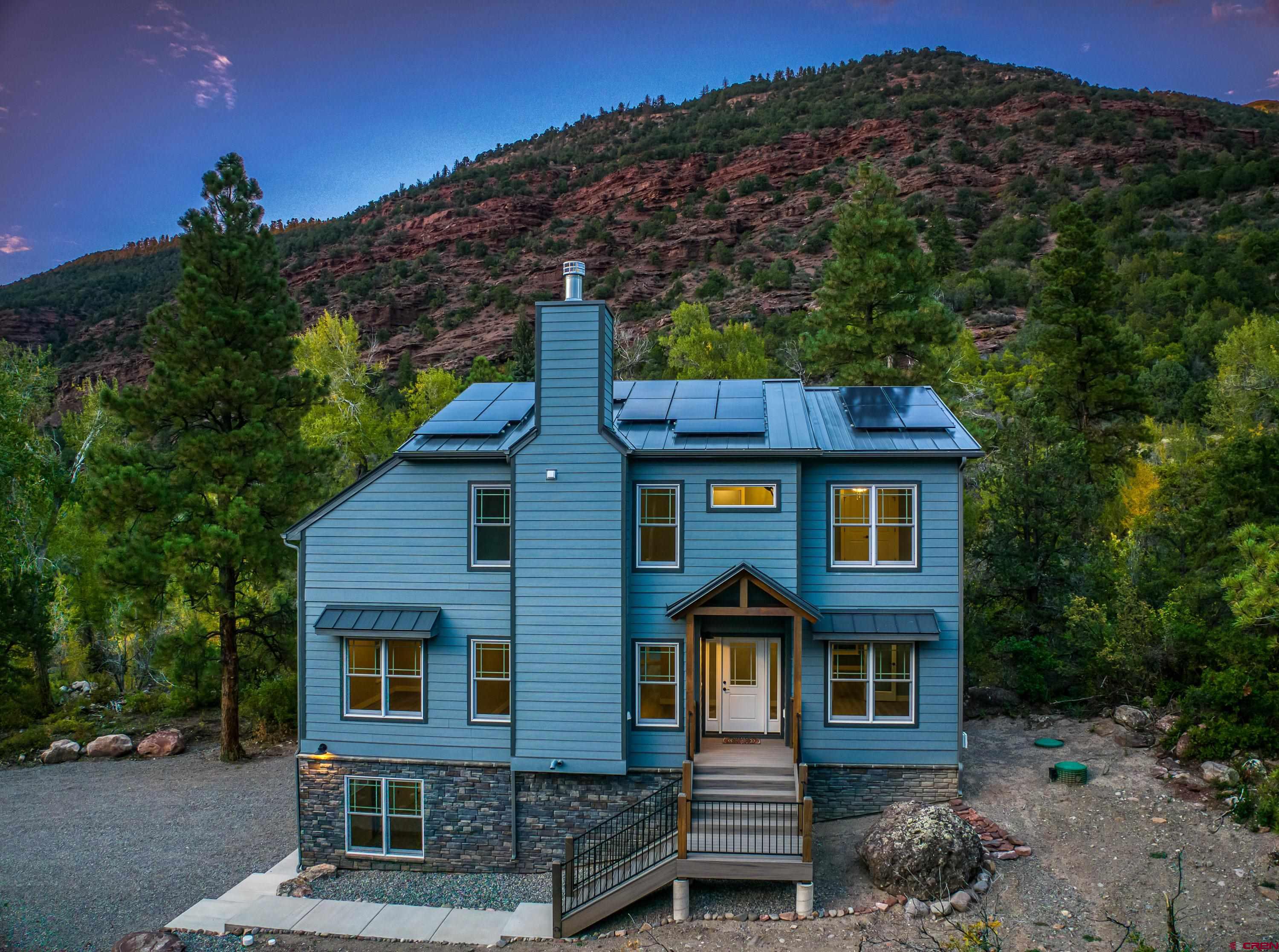 Welcome to your dream mountain home in Ouray County! This brand-new, never-lived-in home sits on half an acre, backing up to Cutler Creek and the San Juan National Forest—giving you endless outdoor adventure right in your backyard.  This 3-bedroom, 2.5-bathroom home features two offices, a formal dining room, and a bonus room—perfect for remote work or extra space.  Built for comfort and efficiency, enjoy solar power credits, dual-zone heating & A/C, a large wood-burning fireplace, and a durable metal roof.  Located just 5 minutes to Ouray and Ridgway, inside the Ouray School District, and only 40 minutes to Telluride and Montrose. The HOA is just $250 a year, covering road maintenance, tree inspections, and access to the cave water system for landscaping and fire mitigation.  With breathtaking views and a 50-amp camper hookup, this home is ideal for families or a high-performing vacation rental"