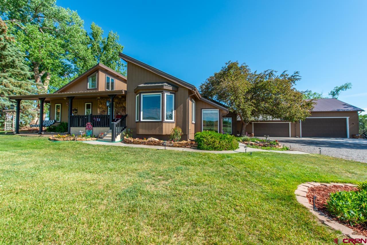 Nestled in the serene landscape of Montrose, Colorado, this picturesque home embodies tranquility and charm. Situated on a sprawling 3.236-acre property, surrounded by lush pastures to the South, West, and North, it boasts breathtaking vistas of both the majestic San Juan Mountains to the South and the stunning Grand Mesa to the North, making every glance a scenic masterpiece. Located in the highly sought-after Spring Creek area of Montrose County, this residence offers a peaceful retreat with unparalleled views. The property features ample space for vehicles and recreational equipment, including a 4+ car garage with a newer 681 sq ft addition ideal for a workshop, garage, or RV storage, complemented by a convenient 24' x 12.5' carport for additional storage needs. Renovated in phases between 2010 and 2014, the home seamlessly blends modern upgrades with timeless elegance. Step inside to discover a beautifully remodeled interior, adorned with exquisite wood floors, upgraded cabinetry, and state-of-the-art appliances in the kitchen and dining area, where an inviting island awaits for culinary endeavors. A cozy sitting area adjacent to the dining room invites moments of contemplation while soaking in the mountain vistas. The sunroom offers a tranquil space for morning coffee or nurturing plants, while the family room provides versatility for various lifestyle needs. The living room, graced by a wood-burning fireplace, beckons cozy gatherings, while two bedrooms with San Juan views and a spacious primary suite, complete with a private deck overlooking the expansive backyard and pasture, offer peaceful sanctuaries. The primary bathroom boasts luxurious amenities, including a spacious shower and double sinks, complemented by a surprisingly large closet concealed behind mirrored doors. Designed with thoughtful consideration for enjoyment, the home features unique spaces, including an upstairs area perfect for an office, sitting room, or additional living space with panoramic views. Outside, multiple decks and a covered front porch offer inviting spaces to bask in the beauty of nature, making every moment spent in this extraordinary abode a cherished experience.