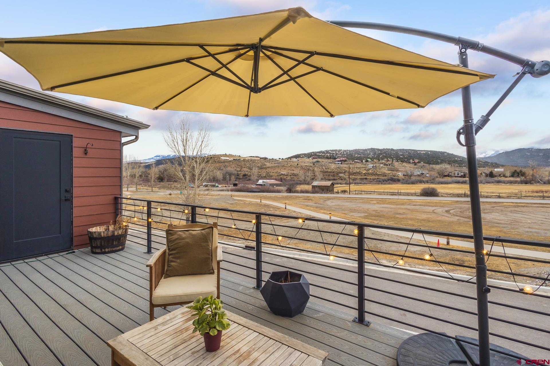 This end-unit home is a testament to thoughtful design and comfortable digs. Remote work, retirement, and family life can all find rhythm within these walls. Step outside, and the living space expands. Breathe in mountain views while gazing at the Cimarron Mountains and the southern San Juans. This mountain industrial style is reimagined for those seeking modern conveniences and clean design. Leave your car in the 2-car garage and explore the heart of Ridgway on foot and bike. Breweries, restaurants, music, and entertainment are all within easy walking distance. Meander through the town park a couple of blocks away, stroll along the river, exercise on winding trails or delve into winter sports. High-quality, low-maintenance exteriors and a clean, bright interior set the tone for refined charm. Call today to see this attractive home in a vibrant and convenient neighborhood.