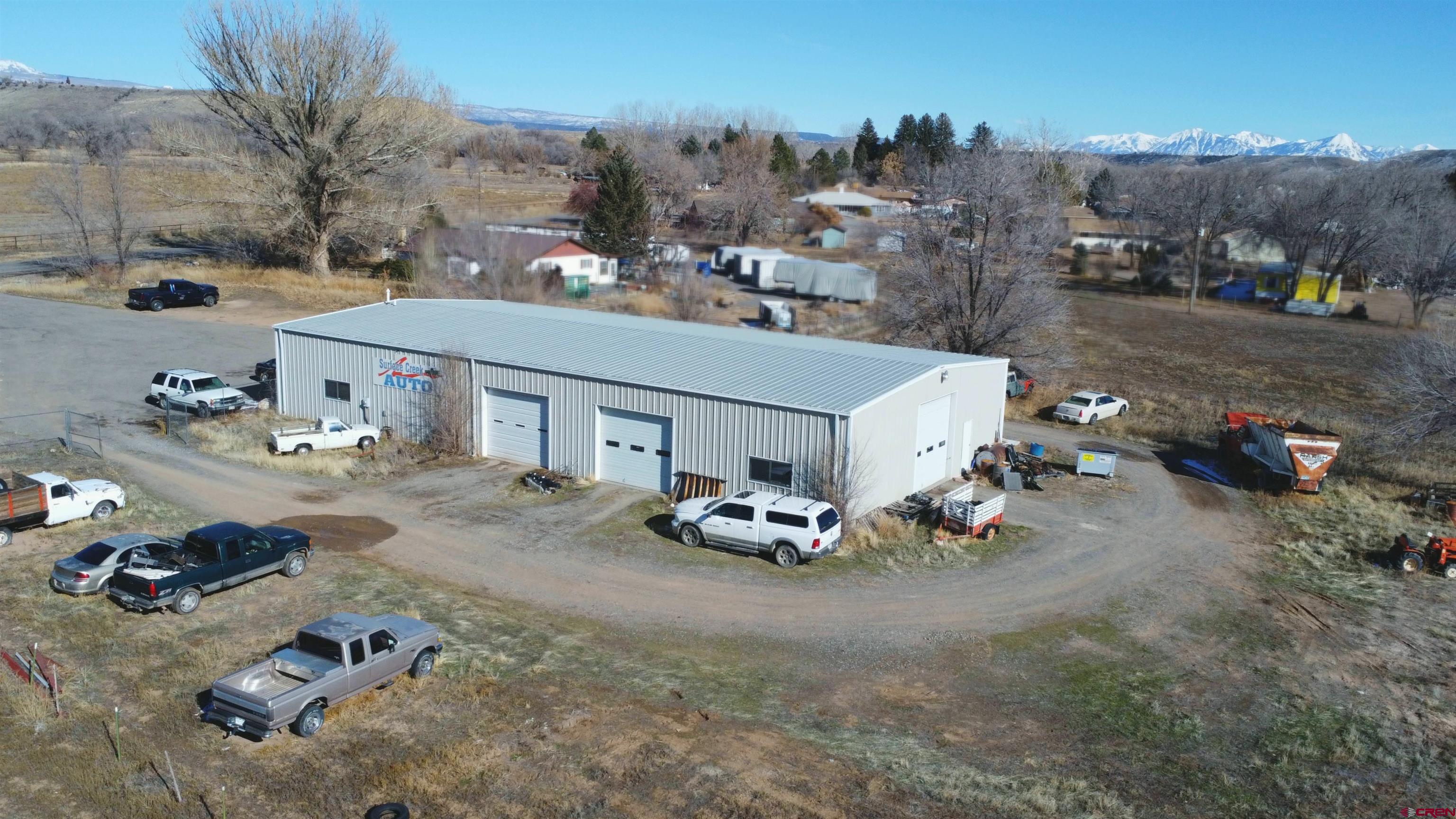 Are you looking for the perfect spot to kick start your automotive dreams?  Or possibly you just need open square footage for a business idea?  Or are you a collector looking to showcase your collection?  Then look no further, because we have an incredible opportunity for you!  This is a well established Automotive Repair Shop with years of service and reputation.  Welcome to Surface Creek Auto.  Nestled on nearly 3 acres of property, this huge steel framed shop building boasts a whopping 4802 square feet of prime heated space.  The property includes a tremendous amount of tools and equipment to help a new business owner get started, or an experienced mechanic to expand their operation.  With two drive-on lifts, a 2 post lift, and a portable lift this shop has space to work on many projects simultaneously.  The doors are configured to be able to utilize a lot of space to make it efficient for multiple areas to produce income.   The shop, office and waiting area, bathroom, and parts room are heated with natural gas in floor heat.  No more crawling around on a cold concrete floor.    The possibilities are nearly endless.  Keep it as a mechanic shop or transform it into the place of your dreams.  Ample parking for lots of vehicles, Highway 65 visibility, and security fencing make this property a must see for many different uses.  The back side of this land is still undeveloped and the property comes with some irrigation water as well.  Let your imagination run wild as you explore this unique property.