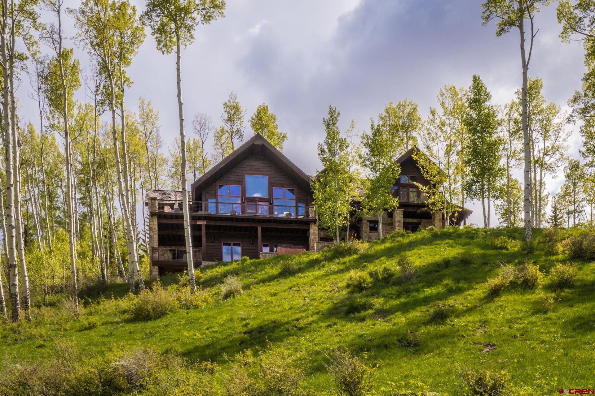 Find a big slice of paradise in one of Telluride's best locations! The stunning setting at this timeless four-bedroom home offers the perfect balance of seclusion and magnificence. With its peaceful cul-de-sac setting and easy access to Telluride's skiing, hiking, and historic town, living in this comforting home is likely the right fit for your family. It is situated on nearly three aspen-filled acres of pristine land with panoramic mountain views and adjoining hundreds of acres of open space. Hear the soothing sound & wildlife sights around Remine Creek on the edge of the property. With stunning stonework, vaulted ceilings, and a practical floorplan filled with ''away'' spaces combined with a phenomenal setting and appealing aesthetic, there is everything to love about this property!