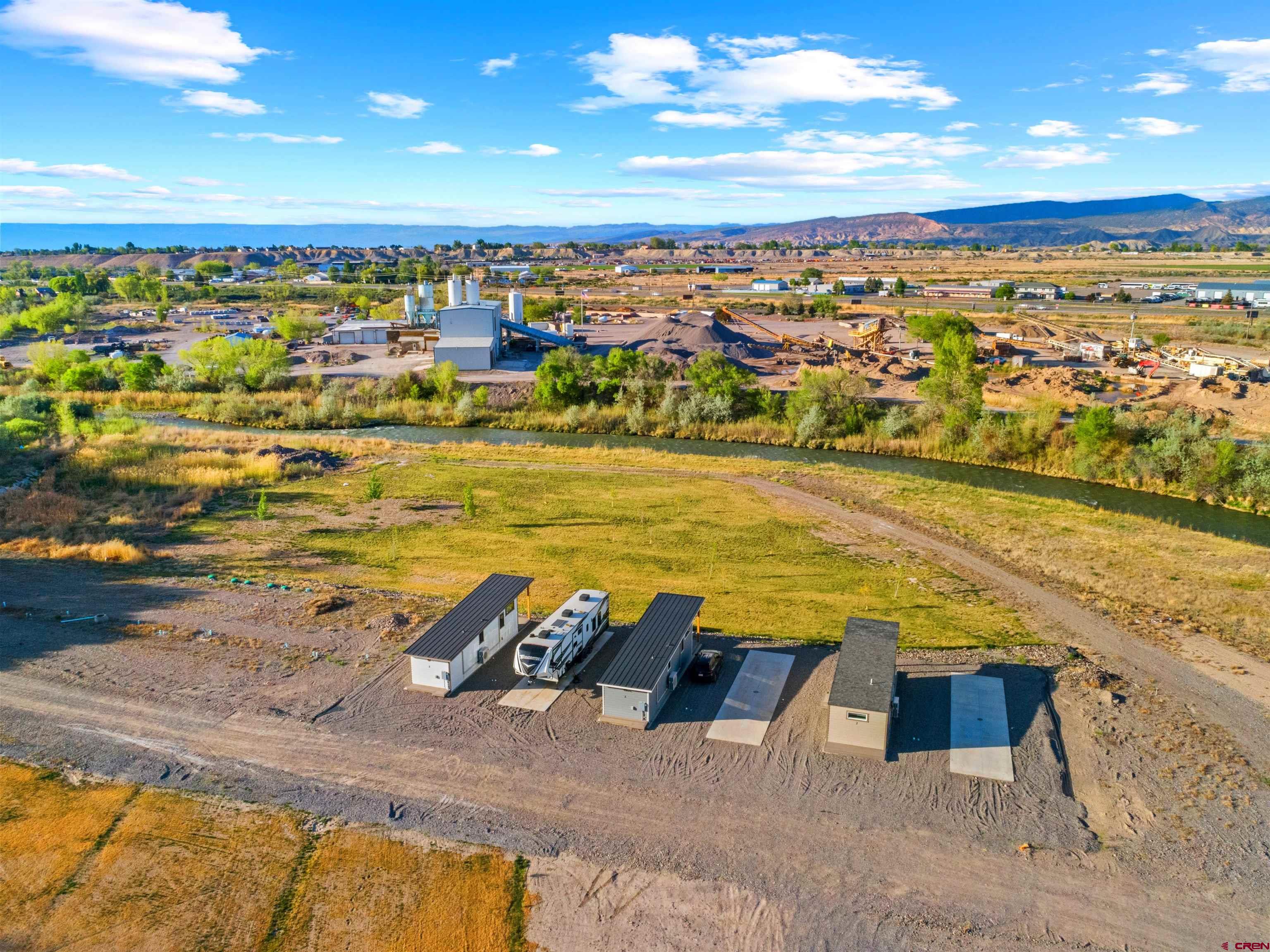 Investment opportunity! A Primary residence (with a long term tenant), large outbuilding that would make an excellent rec center/ office/ laundry and up to 15 RV parking spaces and a large shop! There is room to add more. This is the perfect opportunity for that investor looking for passive income generating opportunity!   Property currently has three tiny homes that are being rented through vrbo that are for sale separately. Call agent to schedule a showing!