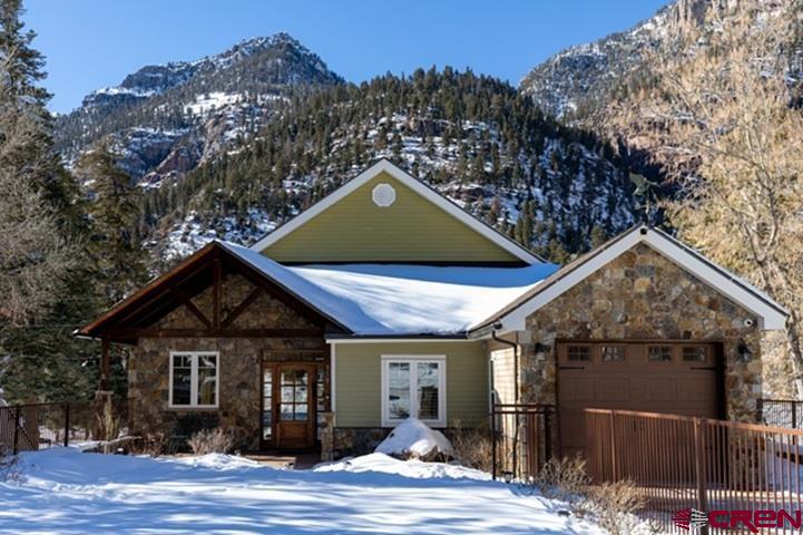 Here it is! This is a unique property with numerous possibilities. It is designed to optimize income potential or to serve as your premier home in a prime location in the beautiful, majestic Ouray Colorado.  This property has great views of the surrounding mountains, is centrally located in the heart of Ouray one block from Main Street and within walking distance of hiking trails, the Uncompahgre River, Cascade and Box Canyon waterfalls, Hot Spring pools, restaurants, and shops.  It is in one of the most beautiful places in the world known as the “Switzerland of America”.  The upper level has 3 bedrooms, 2 bathrooms, a spacious living room that is open to the kitchen and dining room and connected to an expansive 25 x 30-foot covered deck that has incredible views of the San Juan Mountains.  The deck is also plumbed for radiant heat. It has hookups for a gas BBQ and great views; ideal for entertaining. It also has a single car garage upstairs along with a separate stackable washing machine and dryer.  The lower level has ground level walkouts throughout and has 5 bedrooms, 3 bathrooms, and additional kitchen facilities, a kitchenette, and a commercial sized washing machine and dryer. The water has an instant hot feature & all of the showers are handheld & adjustable. Most of the rooms & bathrooms are ADA compliant. It has 2 oversized garages-one with a taller door to accommodate a small RV.  This almost new custom home is not your normal build. Everything is top quality with attention to details; from the in-floor radiant heat to the beautiful high-quality wood grain tile throughout, to the vaulted or 10-foot ceilings throughout or the lower-level family room having been plumbed with a smokestack to accommodate a wood burning stove if desired. The driveway & south walkway have “snow melt” radiant heat to keep the ice off during the winter.  The stairway also has radiant heat. The yard has an automatic sprinkler system with a timer. The lower garage is heated and the upper garage has radiant heat. This unique design allows for a large family or will accommodate multiple family arrangements. This property is Zoned as R-2 with possibilities of turning it into a multifamily property if desired and is currently approved for short or long-term leases.  On top of all these great amenities, the Seller will consider including furniture, decorations, and personal property with a full price offer. Seller will also consider Owner Carry.