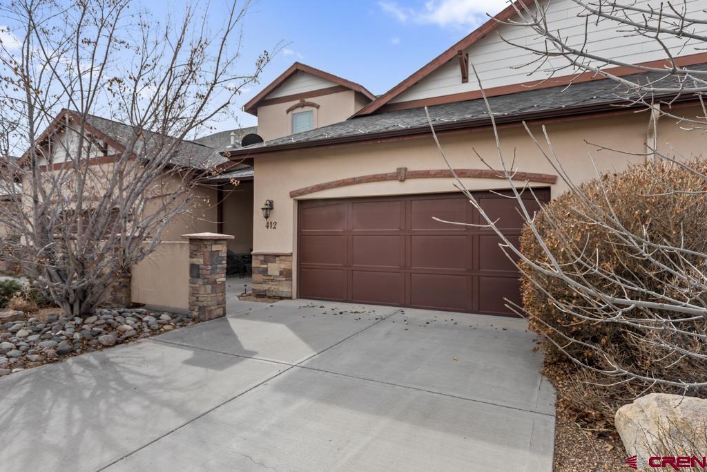 Elegant and expansive, this 2,033 sq. ft. two-story townhome in the heart of Montrose offers the perfect blend of space and convenience. Thoughtfully designed, it features a desirable main-level master suite for ultimate comfort, complemented by two additional spacious bedrooms on the upper level and three walk-in closets for exceptional storage. The open-concept layout enhances the home’s airy feel, while central air, forced air heating, gas fireplace and an insulated 2-car attached garage add to its appeal. Beautiful Alder wood doors with designer lever door handles. Alder cabinets, stainless steel appliances, and hand scrapped engineered hardwood floors. Vaulted ceilings in the living room and 9' ceiling throughout other rooms. Custom blinds throughout the home. The HOA maintains front landscaping and snow removal. The back yard is xeriscaped with a drip for low maintenance. New water heater and Radon mitigation system already installed. Ideally located near shopping, dining, and Black Canyon Golf Course, this stunning home offers effortless living with room to breathe. Schedule your private showing today.