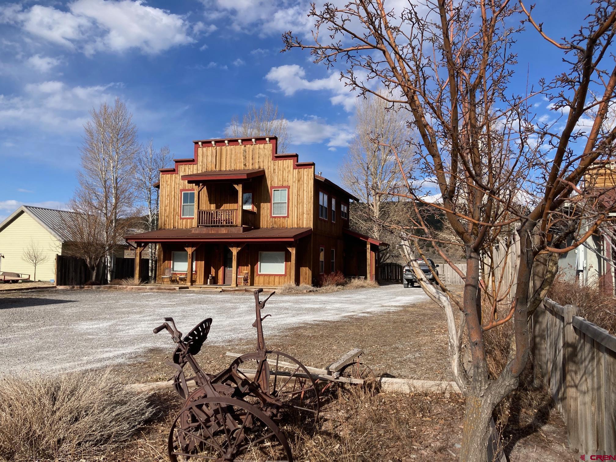 Unique Multi-Use Property in Ridgway – Prime Commercial & Residential Opportunity Seize this rare opportunity to own one of Ridgway’s most versatile and intelligently designed properties! This exceptional General Commercial/Multi-Use building is a testament to thoughtful planning, blending Old West charm with modern efficiency. Whether you're an entrepreneur, investor, or someone seeking a live/work space in the Ridgway, Ouray and Telluride area, this property offers unparalleled flexibility.  Maximize Income Potential with Smart Zoning Strategically built within Ridgway’s General Commercial zoning, this property is currently configured as two distinct residential and commercial rental units:  Lower Level: A commercial space that allows for short-term rentals (up to 29 days) or a variety of business uses, including retail, office space, professional services, breweries, art galleries, or even light manufacturing. Upper Level: A beautifully finished residential unit, ideal for long-term living or short-term vacation rentals (VRBO/Airbnb) under a Ridgway short-term rental license. With this dual-purpose setup, you can generate rental income from both floors or utilize one as a residence while running a business from the other—a rare find in Ridgway!  Designed for Efficiency & Timeless Appeal Built with a classic "Old West" aesthetic, this property blends seamlessly into the vibrant Ridgway community while offering: High-quality materials & craftsmanship, covered parking & dual entrances for convenience, expansive porches & decks designed for privacy and stunning views, landscaped grounds with mature trees & perennials, state-of-the-art heat pump system for efficient heating, cooling, and air filtration. With an impressive building footprint and room to expand, this property presents a prime opportunity for growth. Add another rental unit, increase commercial capacity, or reconfigure the space to match your unique vision—all while maintaining ample off-street parking and accessibility.  Located at the very eastern edge of Ridgway, just a quick walk to the center  of Town, and just minutes from Ouray’s hot springs and Telluride’s world-class skiing, this property places you in one of Colorado’s most sought-after areas for both tourism and year-round living.  Whether you dream of running a business, investing in Ridgway’s thriving market, or creating the ultimate live/work space, this multi-use property offers unmatched potential. Schedule a showing today and start building your future in Ridgway, Telluride, and Ouray!