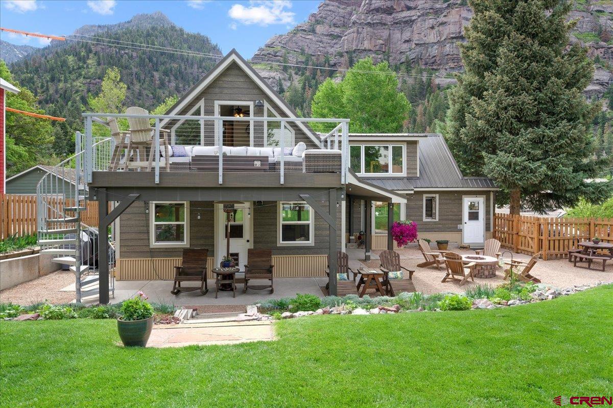 Discover this meticulously maintained, RARE GEM in the heart of Ouray, CO, otherwise known as the Switzerland of America and Outdoor Recreational Capital of CO. This charming home has something for everyone:  1. LOCATION!  Situated just 1.5 blocks off of Main St, it is walking distance to area hiking trails, the world-renowned Ice Park and Via Ferrata, hot springs, Uncompahgre River, restaurants and shops and more…. You can even watch Ouray's fantastic July 4th and NYE fireworks show from the upper deck!   2. HISTORY MIXED WITH CHARM – The Living Room was the original home from 1898 and the expansion of bedrooms, bathrooms, kitchen, etc were done in 1995. Every space in the home is unique and full of personality!  (The shed outdoors is from the 1800’s and was used by the miners to store cupels.)  The home went through a complete exterior renovation in 2020 giving it a true mountain vibe.   3. OUTDOOR RETREAT - Sitting on an oversized corner lot, it comes complete with maintained grounds and flower gardens, new hot tub, gas firepit, covered patio, upper-level deck with exterior spiral staircase----all with magnificent views of the mountains and alpenglow sunsets! It’s the perfect outdoor space for entertaining family and friends with a privacy fence surrounding the property.   4. COMFORT – With its 2 spacious bedrooms (one with a work area), a cozy loft, and 3 bathrooms, it has room for all.  The gas fireplace in the living room, in-floor radiant heat, and A/C split system in the bedrooms make it comfortable in any season.   5. FINANACIAL OPPORTUNITY - Zoned in R-2 allowing for short term rental. House recently went through required City renovations to obtain an STR permit.   Coming COMPLETELY FURNISHED, this one-of-a-kind property is turnkey and waiting for YOU!
