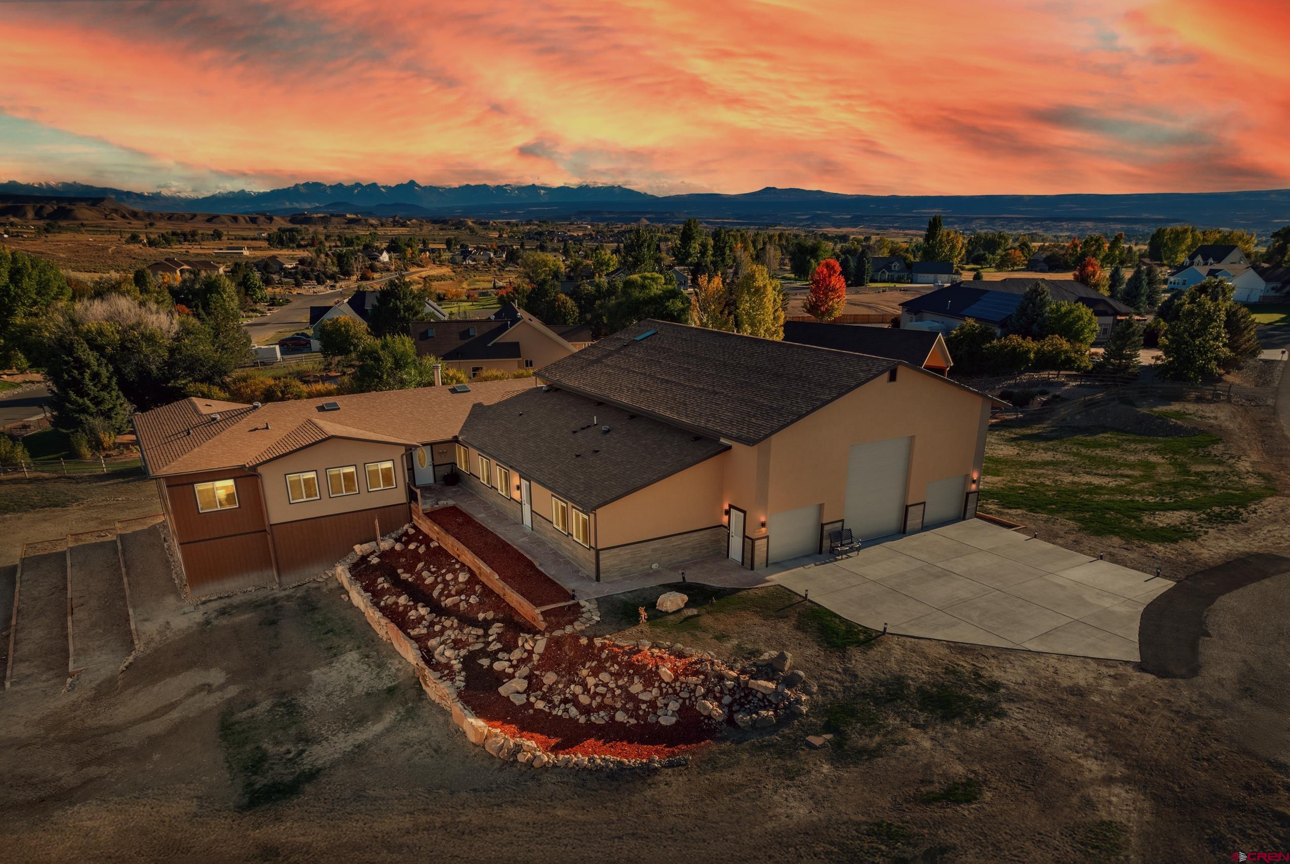 Welcome home to your Luxurious Ranch-Style Retreat on Colorado’s Western Slope. Built in 2021,  this stunning ranch-style home offers breathtaking mountain views, convenient access to the Black Canyon of the Gunnison for rock climbing and hiking, and the Uncompahgre River for rafting and fishing.  Your new home combines an ideal blend of comfort, handicap accessibility in mind when constructed, and modern living. There are a total of 7 bedrooms and 5.5 bathrooms. The private primary suite includes a walk-in closet and deck access. This Colorado inspired home is designed for both relaxation and entertaining in mind. The open-concept living areas features a see-through rock-faced gas fireplace, Coreluxe laminate plank flooring is found throughout the house. while  The sunroom provides a bright space to enjoy the Colorado sunshine while accompanied by the peaceful sounds of the two indoor water features. The spacious kitchen and extra-large pantry include hickory cabinets, an island bar. as well as stainless appliances. The newly recently finished basement with 10- feet tall ceilings adds even more living space to this 7200+ square foot home! In the walkout basement to the outdoor water feature there are two additional bedrooms, a full kitchen, a spacious living area, a flex/media room, 1.5 bathrooms, and a very large shop for your woodworking or other craft skills. A separate mother-in-law/Au Pair suite is complete has with its own separate entrance. This suite offers a kitchen, living room, bedroom, laundry, and ¾ bath—perfect for extended family or guests as well. Aligned with the Colorado outdoor living theme is just as impressive, Hatton Place has with an expansive Trex deck, built-in gas firepit, waterfall, stream, pond, sprinkler system, as well as stunning rock landscaping. This beautiful property is connected to City Water and Sewer and has irrigation water provided through the HOA for your landscaping needs. A massive six-car garage accommodates a 48-ft Class A RV with hookups, plus five additional outdoor parking spaces. The home is highly energy efficient. It has : R-70 ICF walls, R-30 ceilings, a geothermal system, and a reverse osmosis water supply. Your future new home on the Western Slope of Colorful Colorado is located just six miles from Montrose Regional Airport which offers direct flights to major cities and ski resorts. This property is also near the future Montrose Regional Health Ambulatory Care Center, set to break ground soon. With 1.5 acres of serene beauty, accessibility features, and unmatched amenities, this home is a rare find. Schedule your showing today!