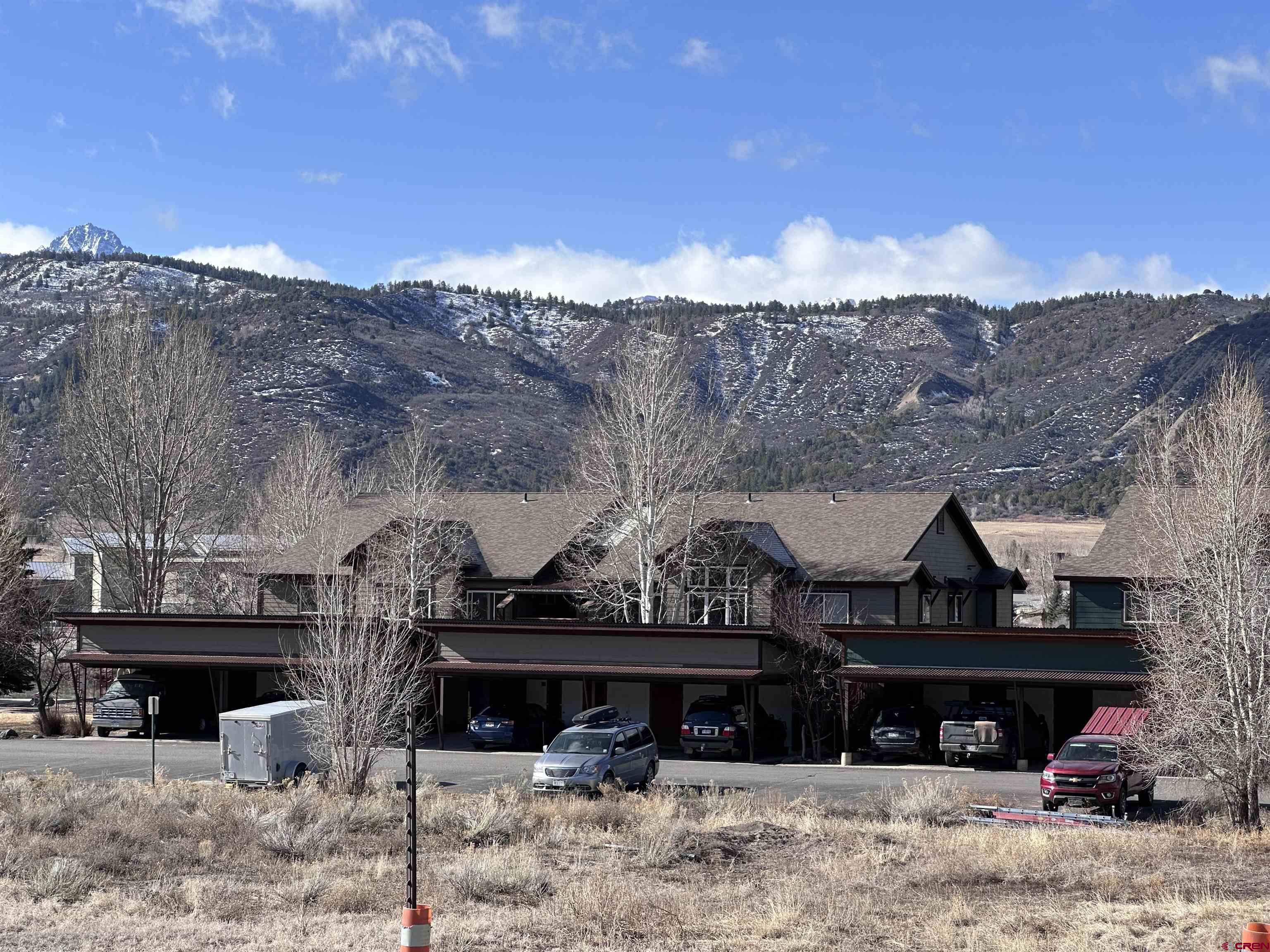Check out this 2 bedroom, 2 bath condo in Ridgway! Located in walking distance to shopping, restaurants and parks! Overlooking the pond, this unit has views of the mountains to the South.  Covered patio, deck with a detached carport and locked cabinet for storage. Professionally cleaned and freshly painted.  This unit is move in ready!