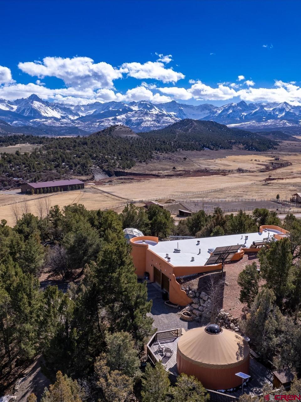 Premier 3.5 acre Pleasant Valley location minutes away from both Ridgway and Telluride with spectacular views of the San Juan Mountains including both the Cimarron & San Juan range. View of 14,000' Mt Sneffels from your living room. Here is your chance to become totally eco friendly. Purchasing this Off-Grid home with all the fine amenities, all organic construction both solar hot water and electricity leaves you free from the dependence on local utilities. Includes a comfortable Guest Yurt complete with its own solar powered lighting, fans, composting toilet, propane faux log stove for heat, fully furnished, plus large redwood deck & storage shed. There is also a geodesic greenhouse with an 800 gallon water tank & solar powered pump for watering. A Tri-County Water  with spigot on the North side of the home  for exterior watering. This home was built using all natural materials to reduce the impact on the environment as well as providing a very healthy home.  Convenient location in Pleasant Point Subdivision on forested lot with junipers and piñon to retain your privacy. Telluride is less than 40 minutes away with world class skiing and only 5 minutes away from the wonderful small town of Ridgway with it’s complete set of amenities plus hiking, kayaking, boating & fishing in nearby Ridgway State Park. Great area for outdoor enthusiasts!