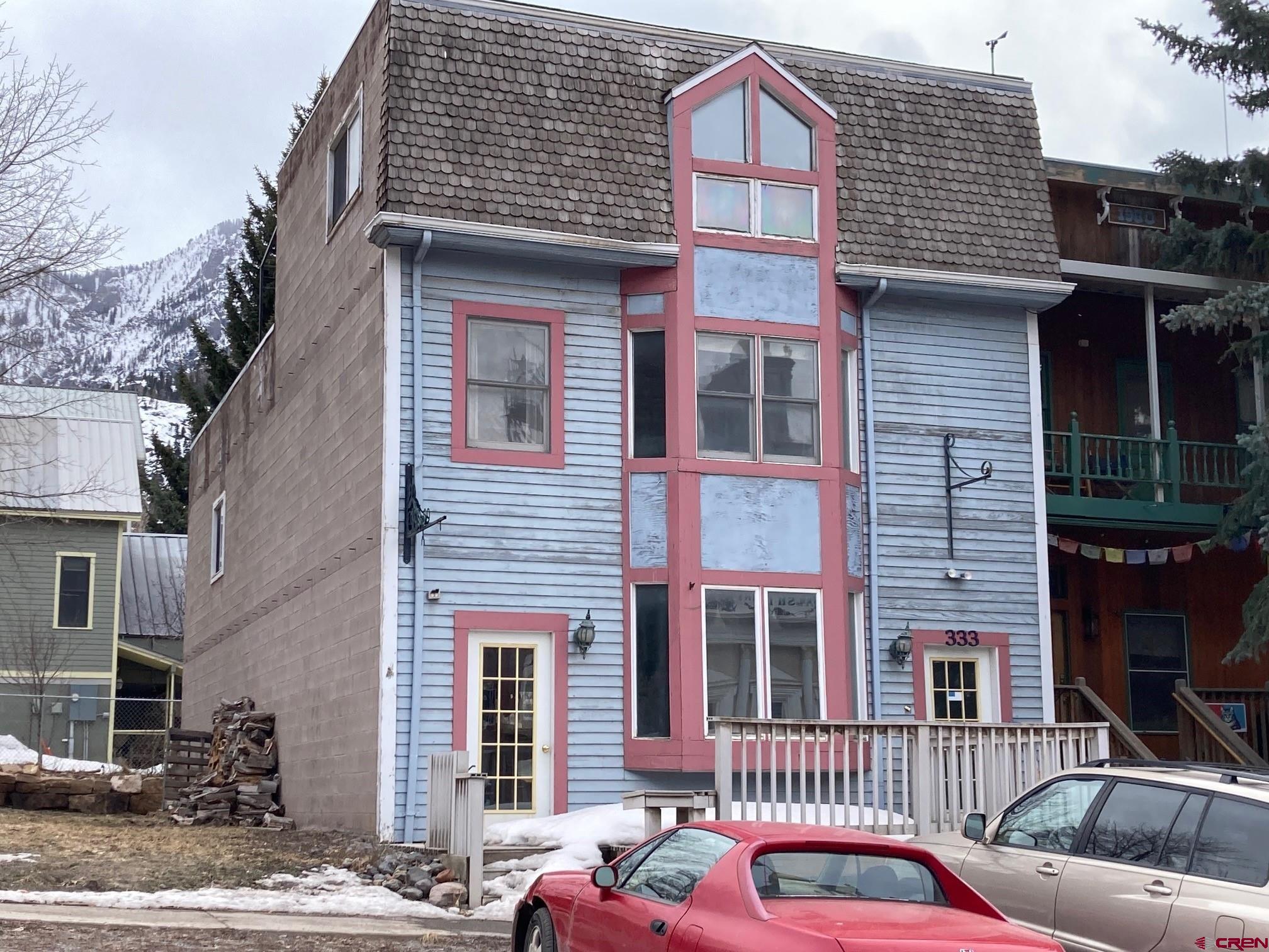 Have you been looking for something that stands out as a perfect residential/commercial building?  Maybe it's a location for your commercial business or office that's extremely visible and located right in the heart of Ridgway, Montrose, Ouray or Telluride?  Perhaps you simply want to have a short term rental along with a more permanent situation for yourself upstairs?  This building, located in the extremely coveted area just uphill from the Main intersection of Main and 6th Avenue will grab your attention.  Zoning here allows residential as well as commercial, and current codes allow short term rentals as an allowable use.  It's important to note that short term rental is simply under 29 days, so there's lots of room to make this a prolific VRBO or A BnB property that will attract tenants who want to be right in the Town Core, with easy walks to the shops, Town Hall, festivals, the Pool, and even the World renowned Perimeter Trail.  The lower level needs to have some form of commercial flavor, as patron walk along the sidewalk on 6th Avenue.  You'll see interior shots that represent a former coffee shop-with large windows along its south end, beautiful polished brick floors, counters well established for serving, and a bank of windows along its back to bathe the space in light year round.  There are  two gathering areas-one in front and one in the back, with a very flexible prep area in its core and 1/2 bath along the front on the east side.  Stairs along the building's west side bring you up to a roomy 3 bedroom, 2 bath living unit that has a dramatic floorplan, with roomy kitchen and living room and an 'Owner's Suite' upstairs.  There's a small deck that extends out the second level overlooking the mountains to the south and one very large deck that provided incredible views across Town to the Rock of Ages, Town Hall, and various city landmarks, like the Pool. There is roughly 1850 sq ft in all, with 1250 on the second floor and 500 on the third.  It's open and gets great light due to the abundance of windows on the south side.  The kitchen, dining and living areas are largely open and nicely sized, and you'll appreciate the cabinetry and layout of the kitchen.  This level has a very nice bathroom with walk in shower, that's accessible directly from the bedroom or from the hall.  Stairs along the back lead you to a dramatic suite on the third floor.  It has a nicely sized bedroom on its north side and a very fun bath with tiled shower and soaking tub tiled combo in back-wait til you see the views!  There's a bridge style walkway that leads to the very large deck, which offers some of Ouray's best views.  It has a wrought iron frame, designed for a cover that can be created to provide protection from the sun and elements and add an extra flare.  The building is in need of upgrades and repairs.  The structure is rock solid and level, but the roof lines have created challenges, and there is significant water damage to the ceiling and walls.  The perforations for chimneys have created additional challenges.  Nevertheless-the building is priced to sell fast and there will be great interest due to the price point and prime location.  You'll instantly see how the building fits into your Ouray plan.  Come take a look-you'll love it!