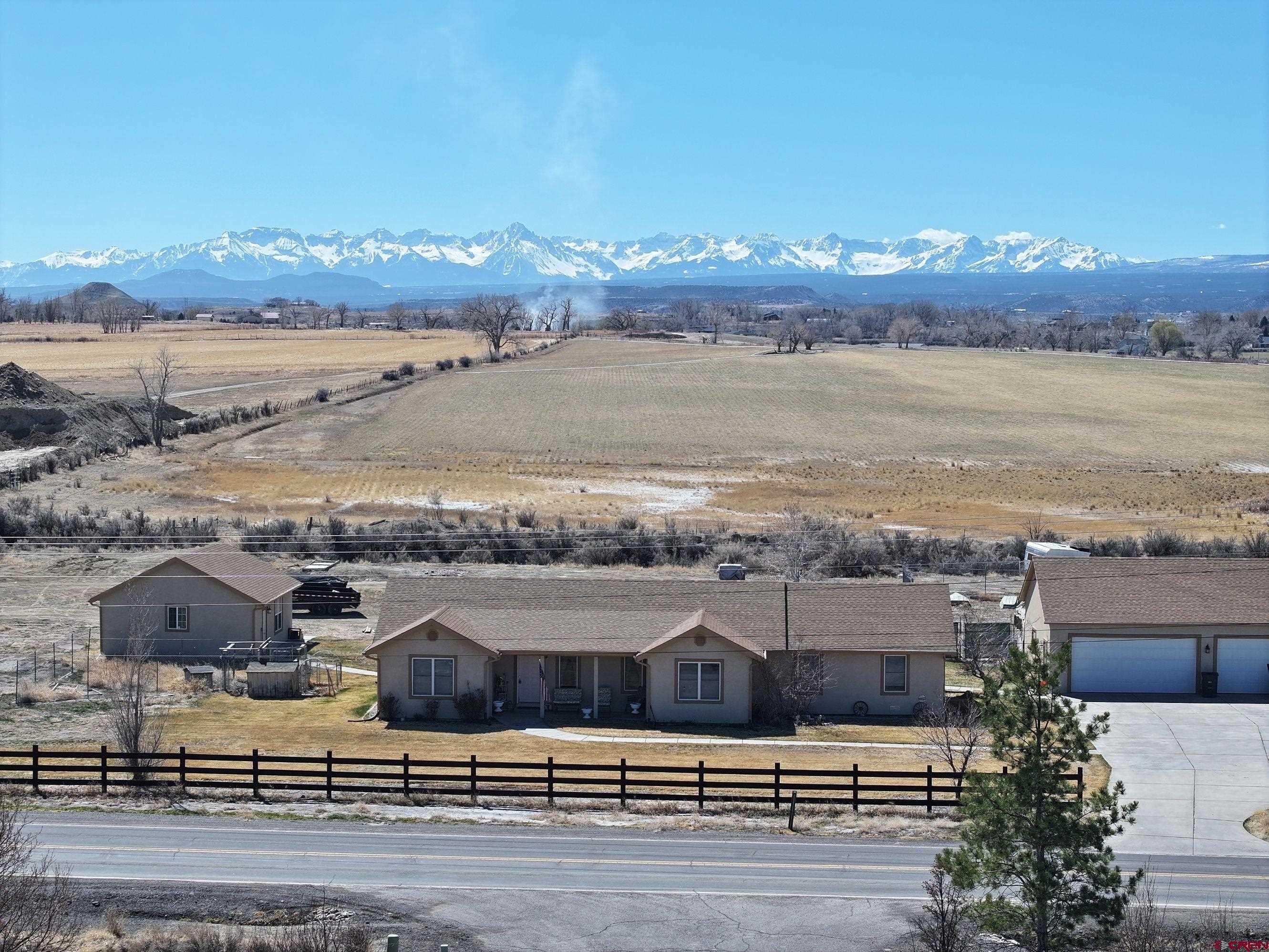 Charming Country Home with Stunning Mountain Views. Discover this exceptional 2,191 square foot residence nestled on 2.9 acres, offering breathtaking views of the San Juan Mountains. This spacious home is perfect for those who crave the tranquility of country living while being just minutes away from town and the renowned Bridges Golf Course. Key Features of this home are the 4 bedrooms including a large primary suite with a private bath featuring a generous tile walk-in shower. A separate office space ideal for remote work or study. Expansive living room and dining room, complemented by a beautifully updated kitchen with modern appliances and elegant granite countertops. There are 3 additional bedrooms and full bath that provide ample space for family or guests. The exterior highlights are the detached garages; A 24'x32' two-car garage, a 32'x36' three-car garage, and a spacious 40'x60' shop, perfect for all your vehicles, RVs, and storage needs. The back patio is an ideal retreat for relaxation and entertainment, featuring a permanent covered gazebo and 220-volt power supply for a potential hot tub. This property seamlessly combines comfort, space, and stunning natural beauty, making it a perfect family home or a peaceful getaway.