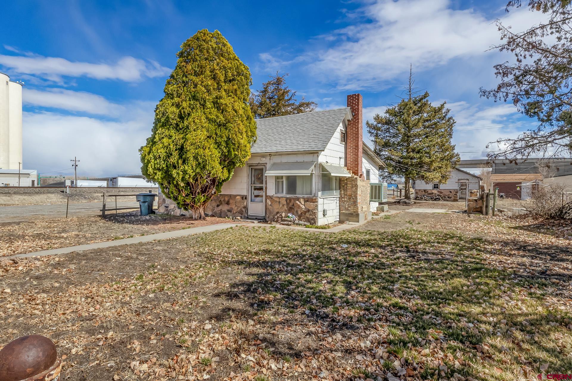 This 2 bedroom, 1 bathroom home situated on a large corner lot is ready and waiting for a visionary to re-create it! Interior features a large living room with a fireplace and a kitchen with an abundance of cabinet space along with an overall functional layout. Exterior features mature trees within a spacious yard. With a little love and creativity this could be an excellent property! Come see for yourself the potential this home holds.