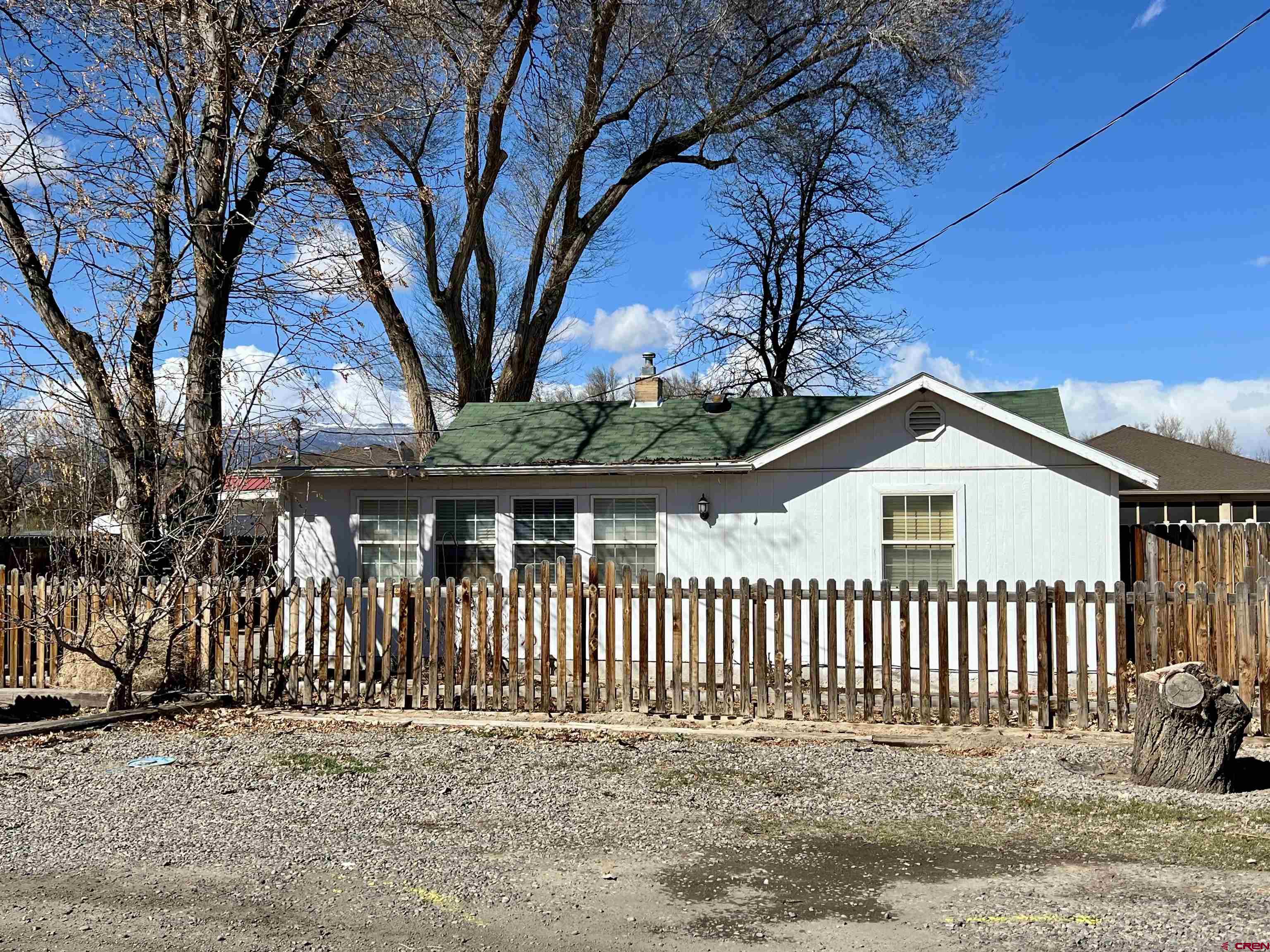 Charming 3-bedroom, 1-bathroom home offering 1,625 square feet of living space on a 0.17 acre lot with tons of potential! Inside you'll find a well-proportioned layout with a large living room, updated kitchen, and spacious dining room. Primary bedroom features double closets and access to the attached garage. Covered carport on east side of home offers additional parking room with access to living room and kitchen. Located on Garnet Mesa, this property provides convenient access to essential amenities and local attractions, including Mountain View Park, several schools, and Delta Health Hospital and medical offices. Outdoor enthusiasts will appreciate the proximity to recreational areas offering opportunities for various activities. The majestic Grand Mesa only a short drive, providing year-round recreational opportunities from hiking to skiing. For travelers, Montrose Regional Airport is only about 25 minutes away and Grand Junction airport is within an hour!  This property presents an excellent opportunity for buyers looking to add their personal touch through updates and renovations. *Estate sales are tentatively planned. Try to look past the personal belongings in the home and garage*