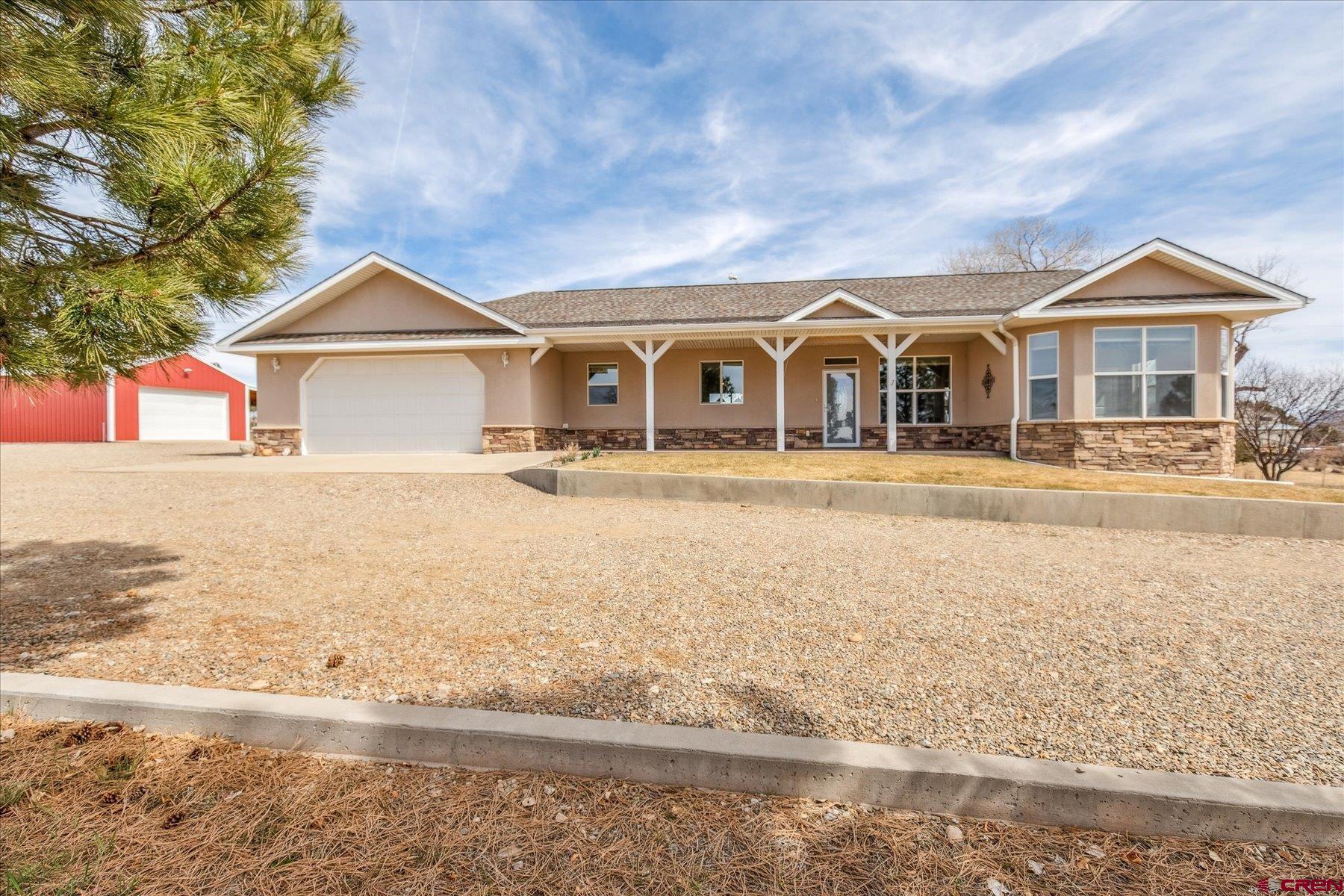 If your dream is to wake up in the morning and open the blinds to a view of the sun rising over snow covered peaks, we can help make that dream come true. After moving off of the farm just down the road, Mom and Dad along with the builder Cruzan Construction collectively designed the quality constructed and beautifully maintained 3 bedroom 2.5 bath home. This country home comes complete with nice amenities such as cultured marble window sills and bath room enclosures, oodles of recessed lighting and a gas fireplace in the living room complete with a surround sound system, oversized door ways and a fantastic laundry area. This gem is located in a historical area of County Road P free of covenants with very convenient access to Cortez and Dolores along with other destinations such as McPhee Reservoir, Summit Lake and Mesa Verde National Park. The home is Geo Thermally heated and cooled with in floor radiant heat and vented cool air. Adding to the homes efficiency is the insulated foundation and subfloor. The open floor plan and beautifully designed kitchen and dining areas are full of natural light compliments of the large and plentiful windows allowing access to astounding views of the surrounding mountains and the beautiful irrigated perennial gardens. A lot of thought went into the design and placement of the garden beds in order to minimize work and maximize blooms all summer long. There are several access points to the large, covered patios on both the east and west sides of the home. These are wonderful areas for entertaining and enjoying the surrounding gardens or just evenings of light discussion and doing nothing but listening to the breezes through the long-needled pines and watching the fading sunlight over the mountains. Aside from the oversized 2 car attached garage complete with a set tub, there is a 430 sf detached shop with an attached lean-to. The shop has plenty of electrical power with an electric garage door opener as well. There is an outside work area under the lean to with a small bench.  Plenty of room for RV parking too. It's rare to have the opportunity to find a country home and property that's not too big and not to small with no one breathing down your neck telling what you can or cannot do. Beautiful views, great setting, well maintained and efficient. It's country living at it's finest. Come on Home.